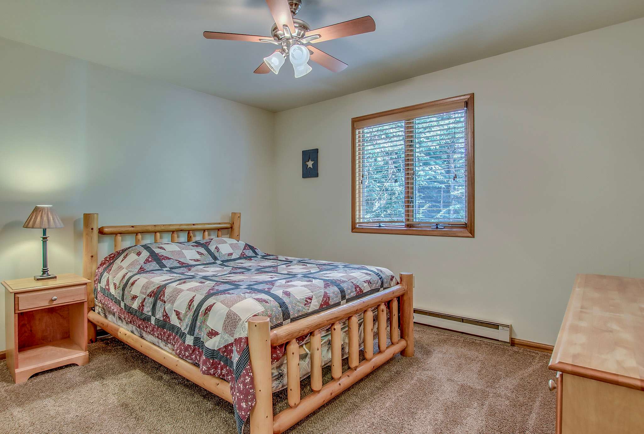 Restful twin bedroom with ceiling fan and soft blue tones for sweet dreams