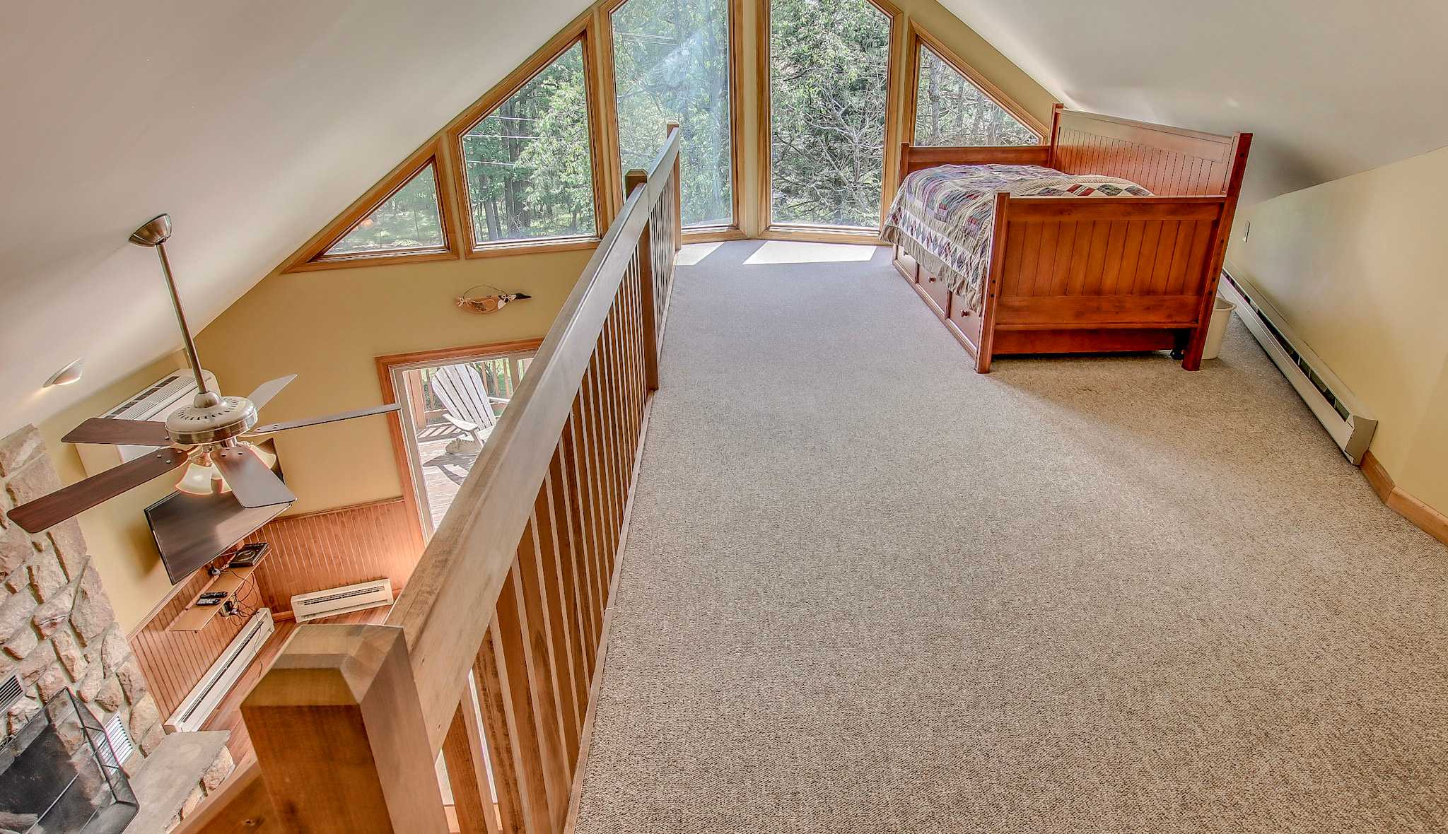 Loft bedroom with stunning A-frame windows and treetop views for a unique retreat
