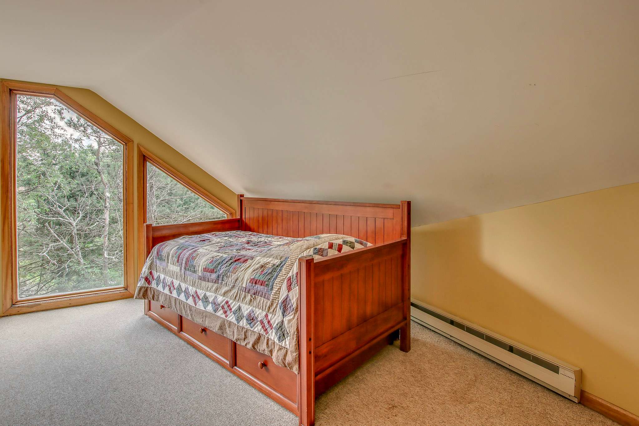 Wake up to forest views from the private loft bedroom on the top floor