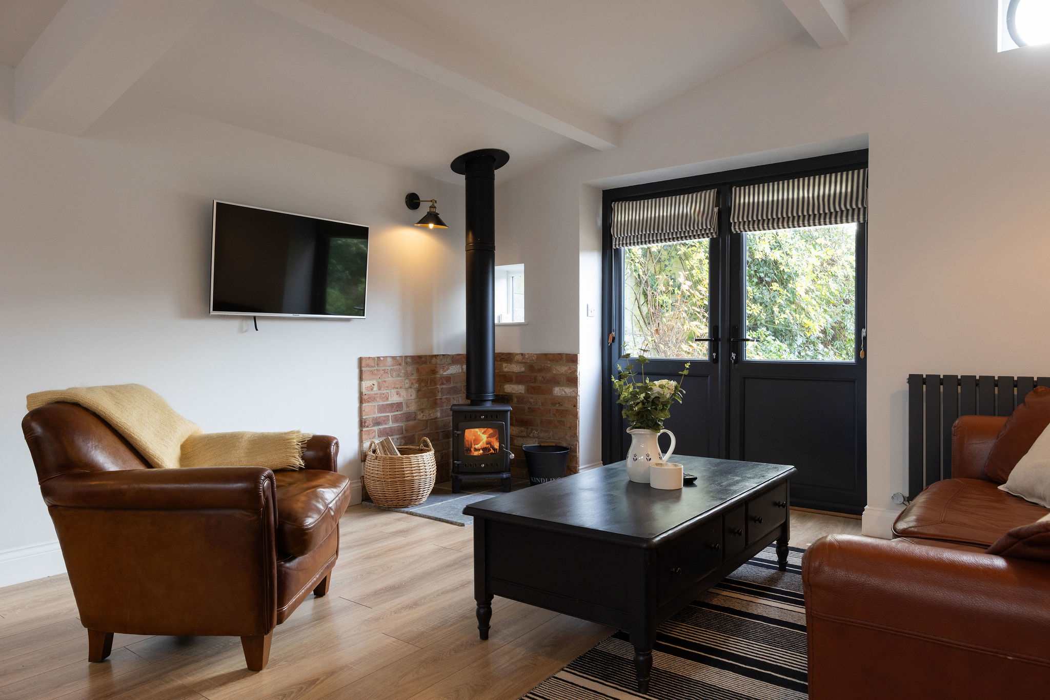 Living room has a smart TV and woodburner to enjoy