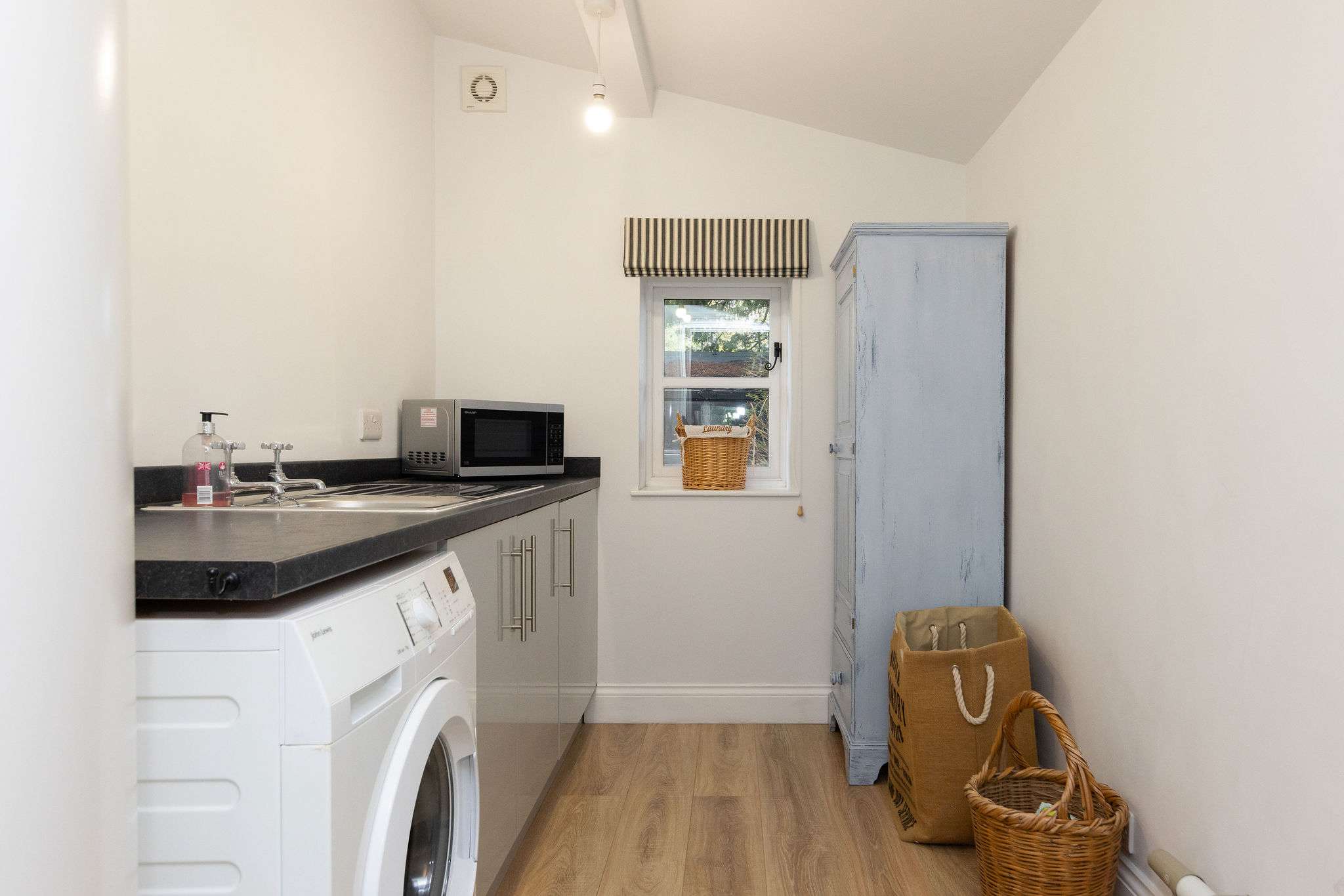 Utility room with washer and sink