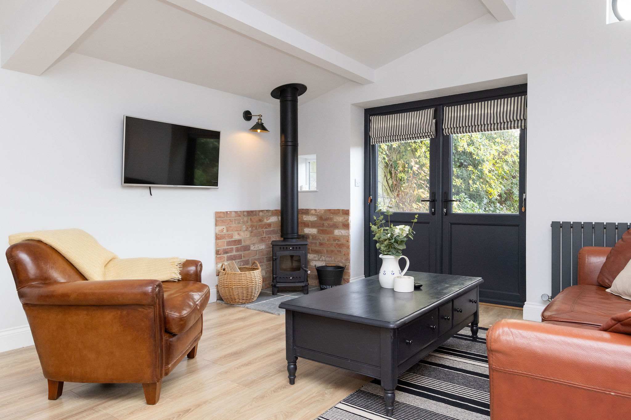 The living room has a smart TV and wood burner to enjoy!