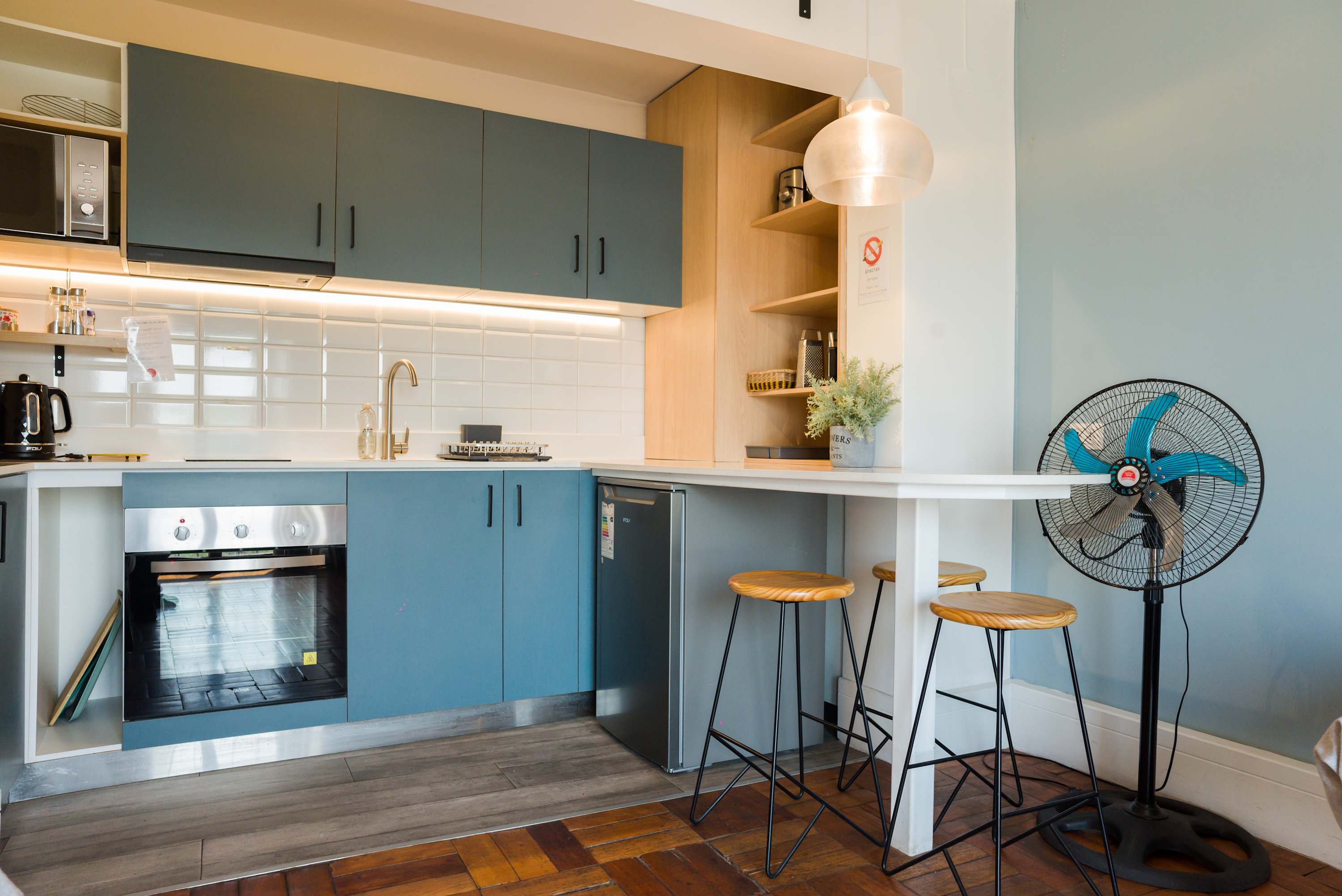 Chic and modern kitchen with stylish bar seating, perfect for enjoying a meal or a quick coffee.