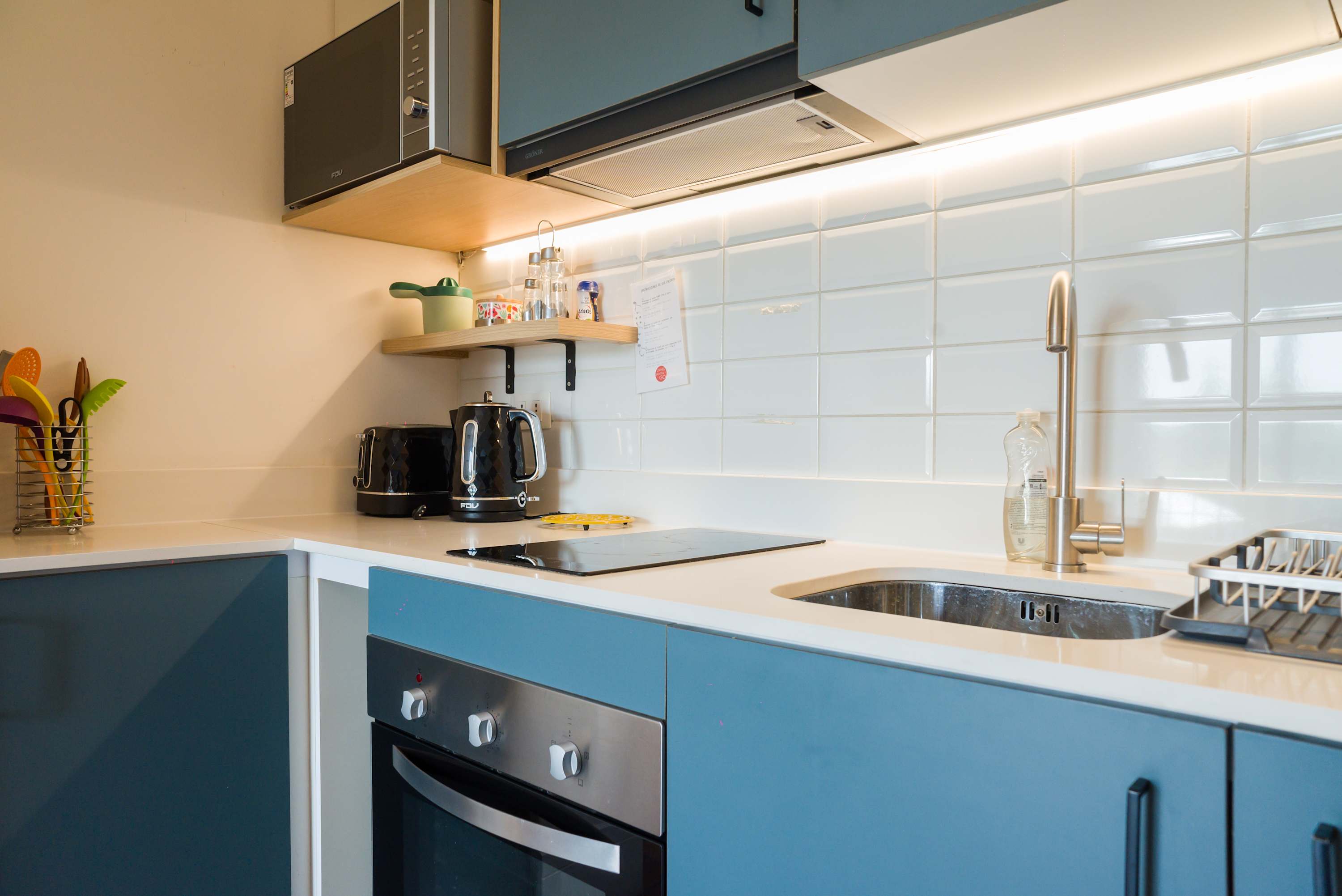 Sleek and modern kitchen with all essentials for a comfortable stay in the heart of the city.