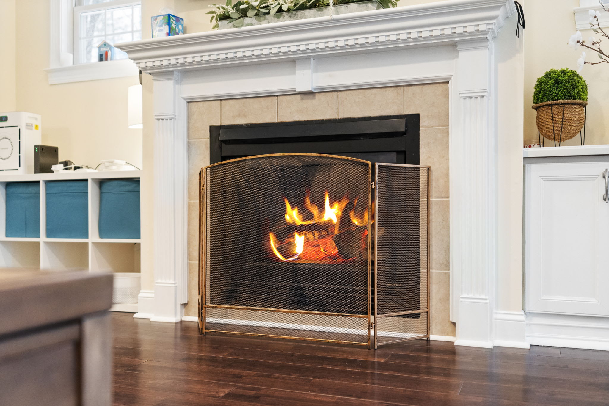 Warm living room with cozy fireplace and built-in shelving - perfect for chilly Poconos evenings