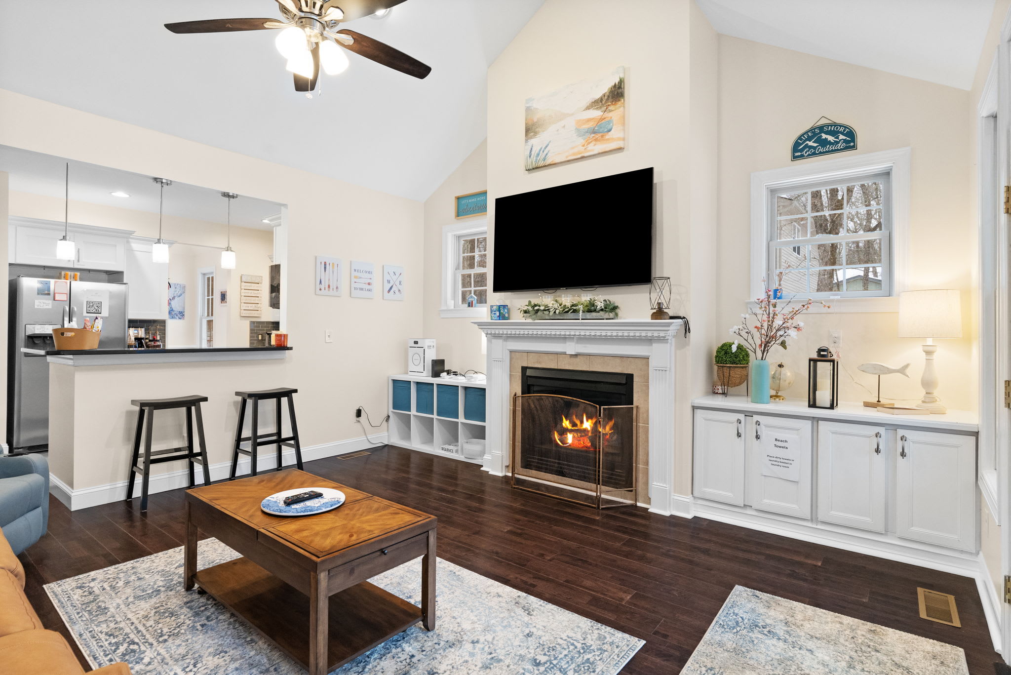 Cozy living room with smart TV, comfortable seating and game table for family entertainment