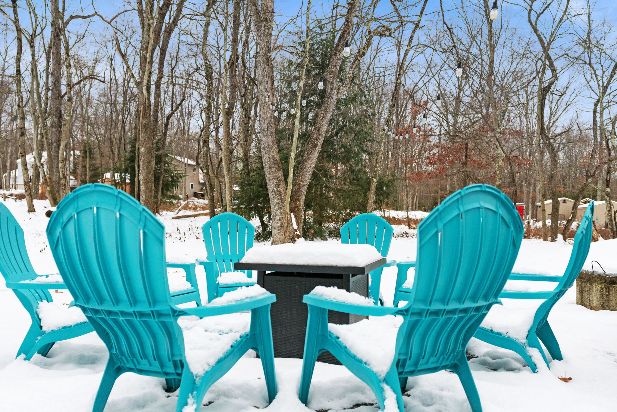 Charming outdoor seating area with teal Adirondack chairs - enjoy your Poconos retreat