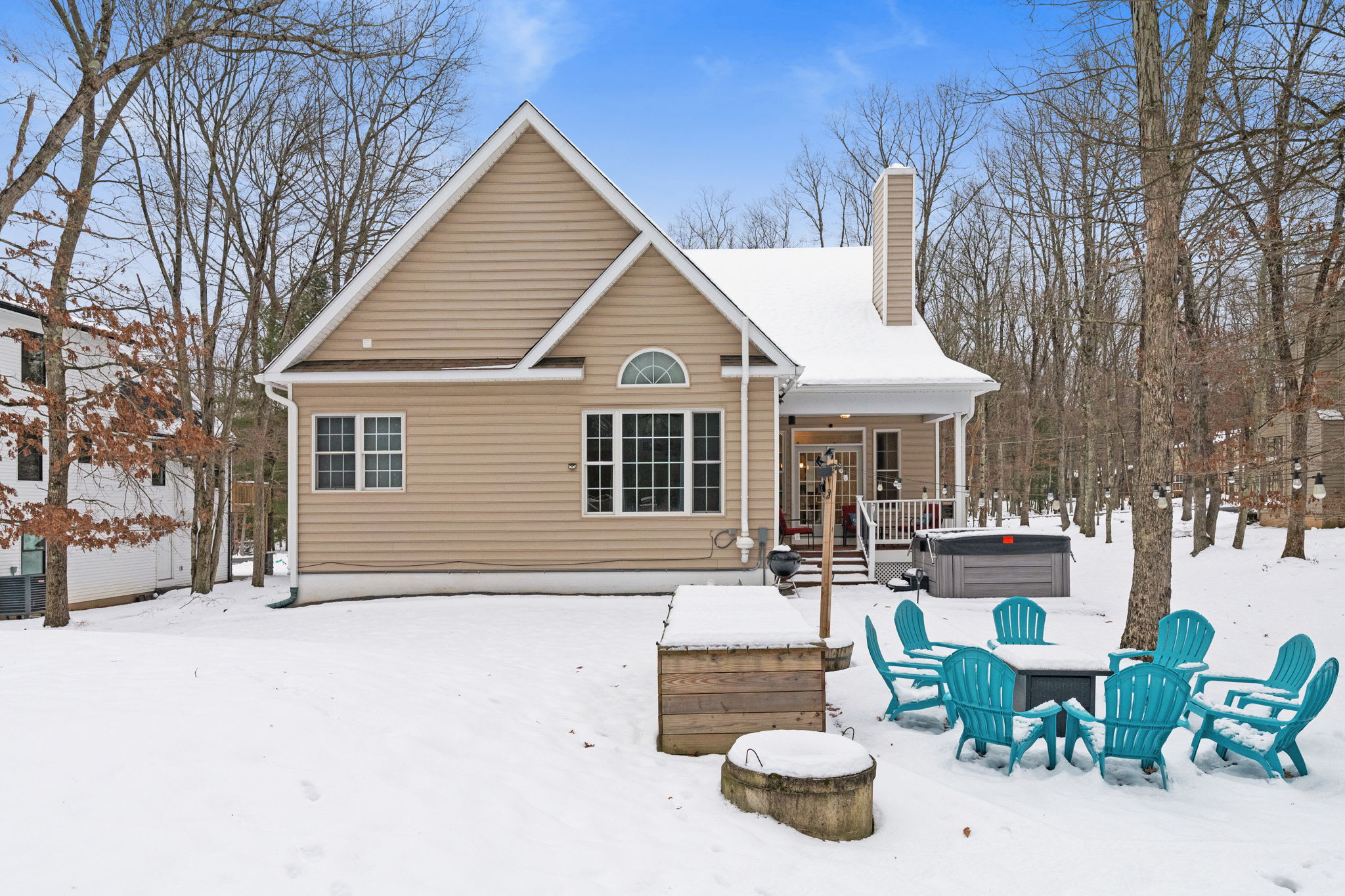 Winter wonderland view of Poconos cabin with outdoor seating in Albrightsville PA
