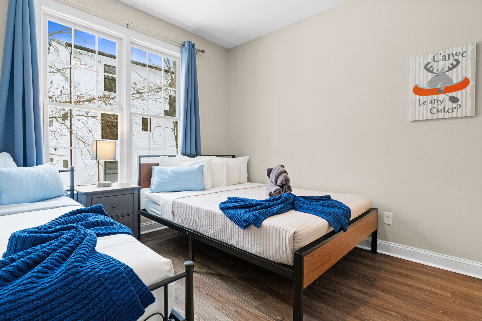 Versatile second bedroom with single bed area featuring colorful artwork and cozy ambiance