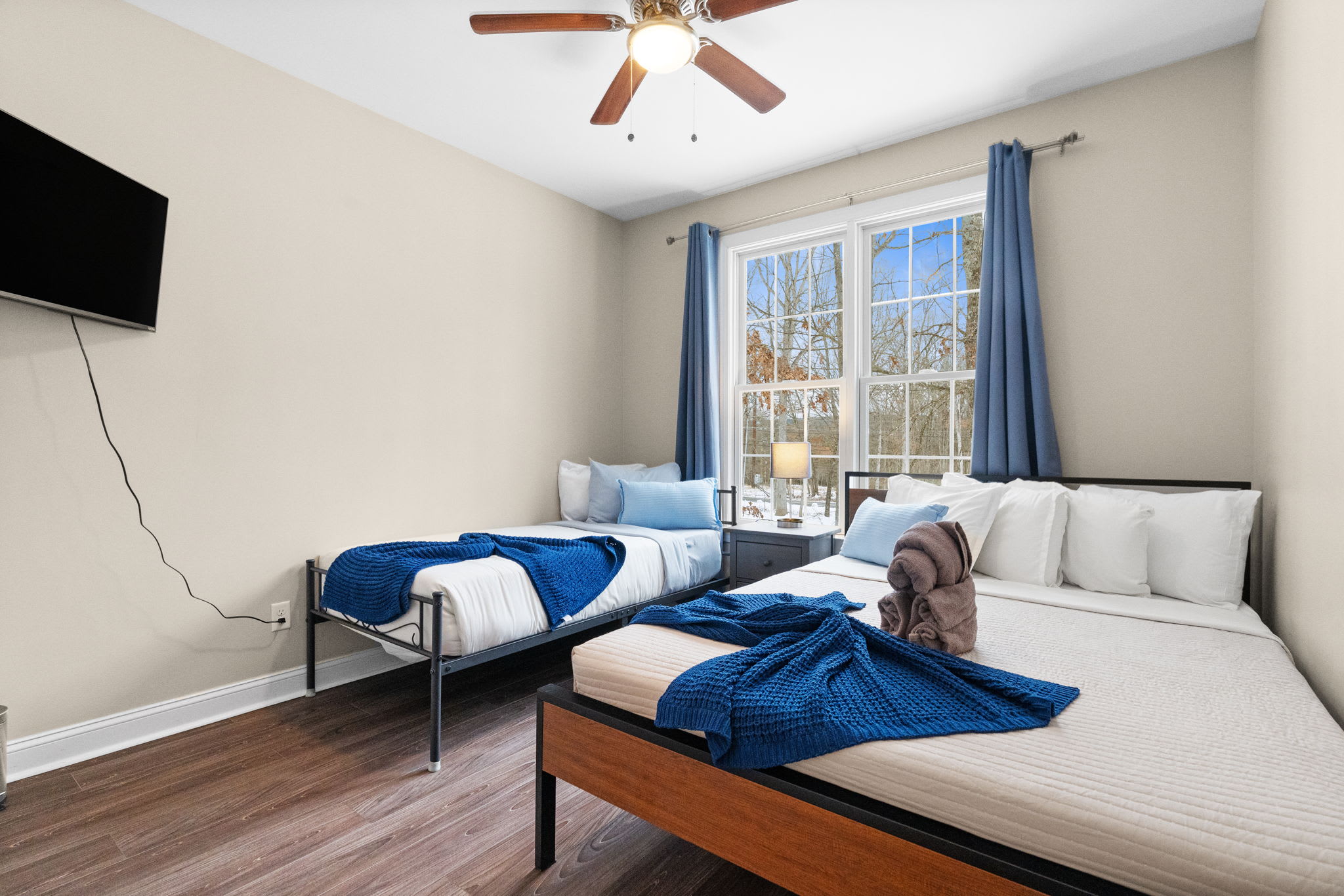 Second bedroom with queen and single beds - bright and airy with stunning woodland views