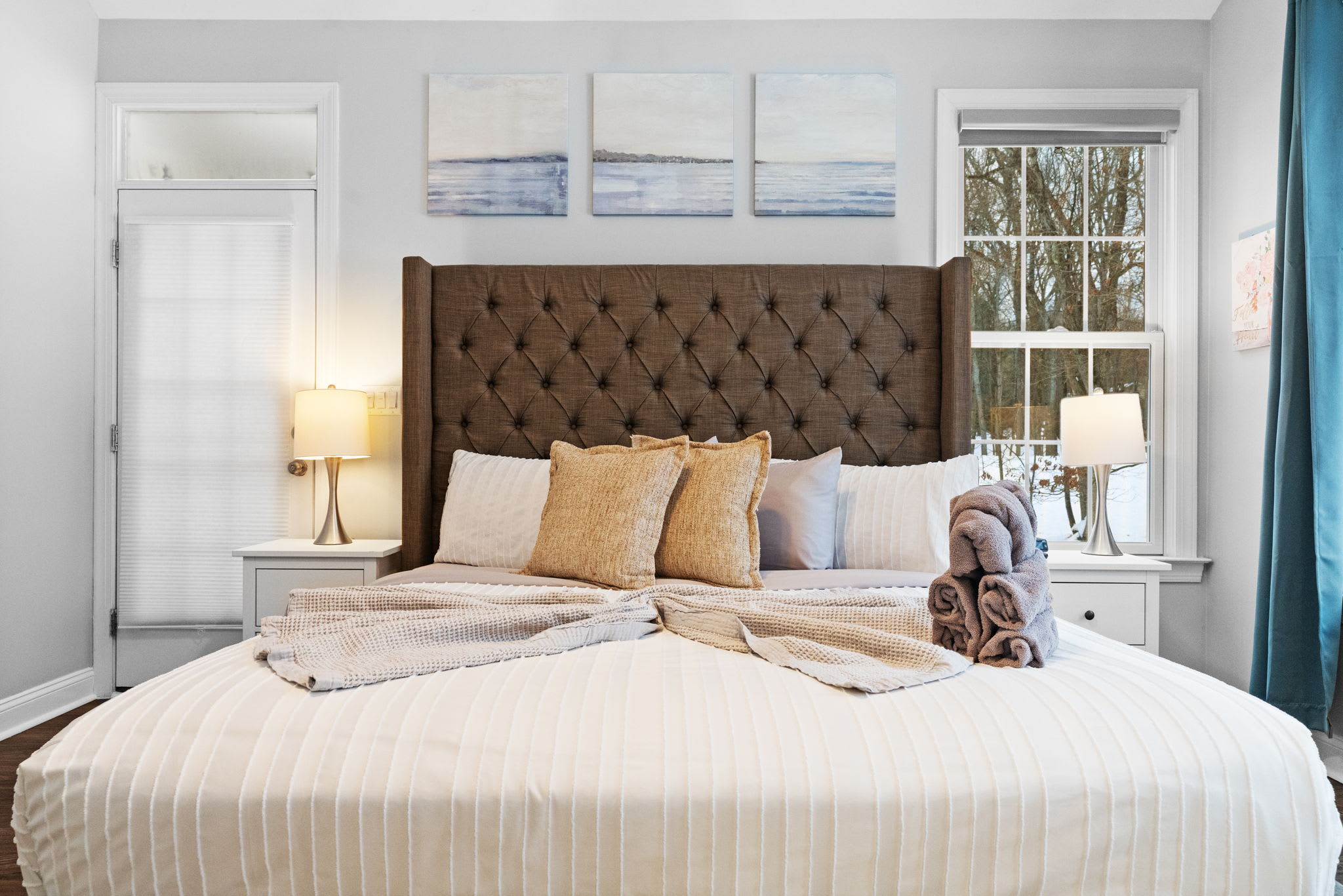 Stunning master suite with king bed, tufted headboard and plush bedding for restful nights