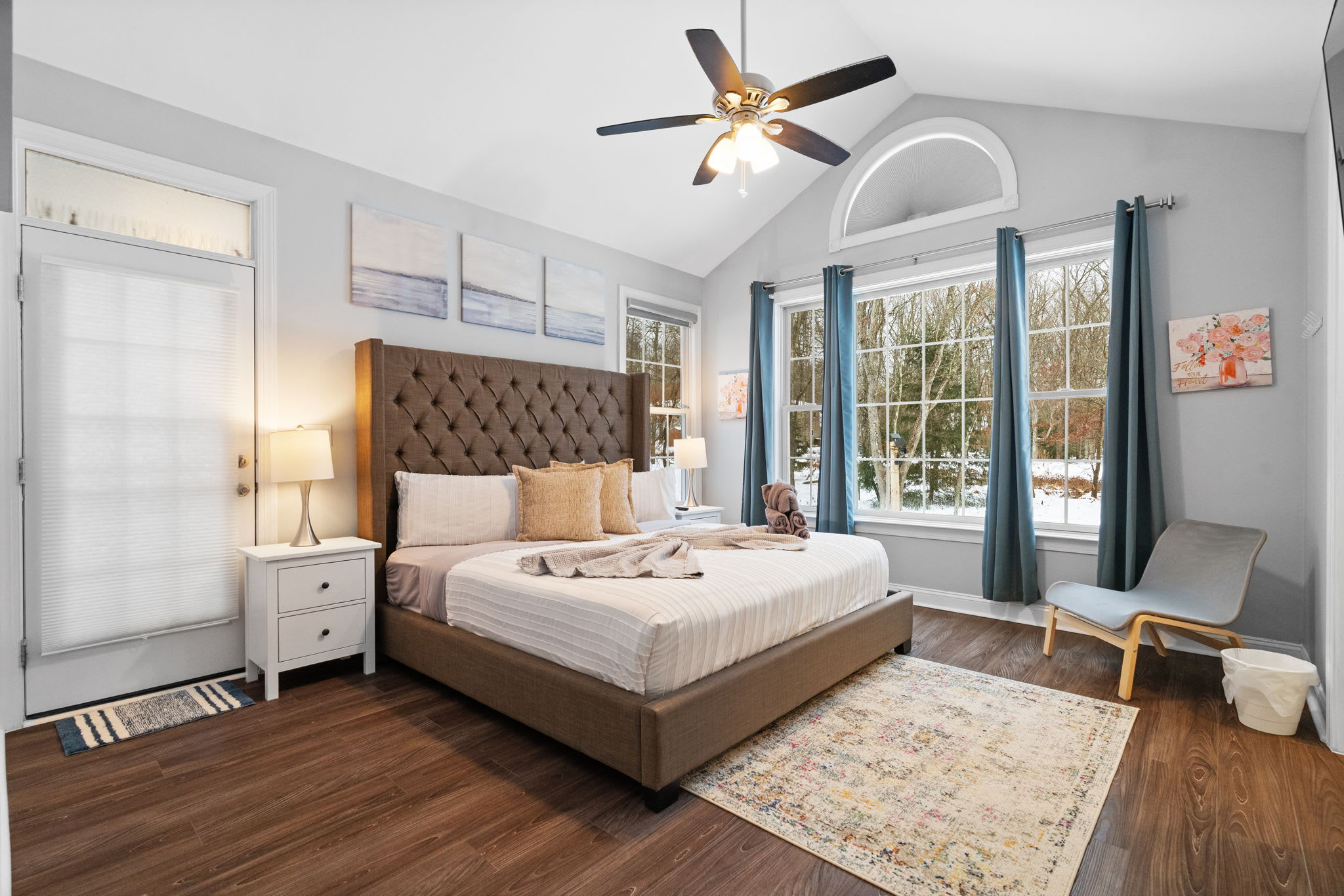 Luxurious master bedroom with king bed, elegant decor and bright natural lighting in Poconos retreat