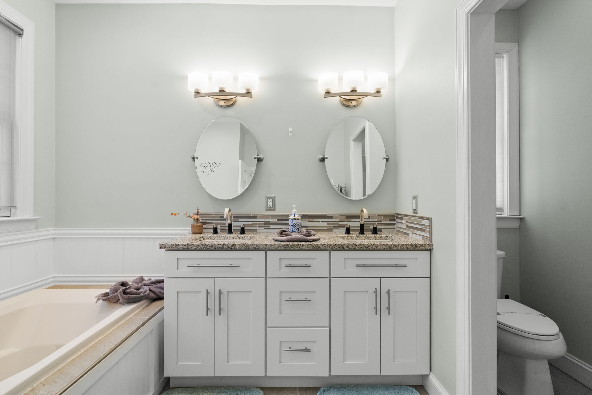 Elegant second bathroom with double vanity, stylish pendant lights and modern finishes
