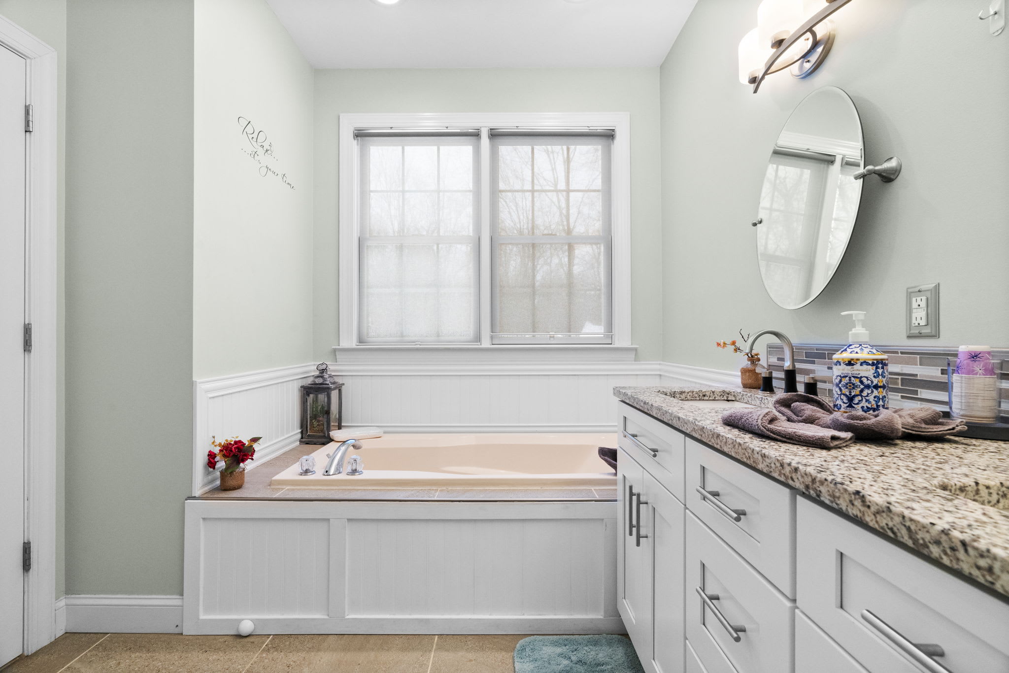 Spacious second bathroom vanity with granite countertop and storage space in Poconos cabin