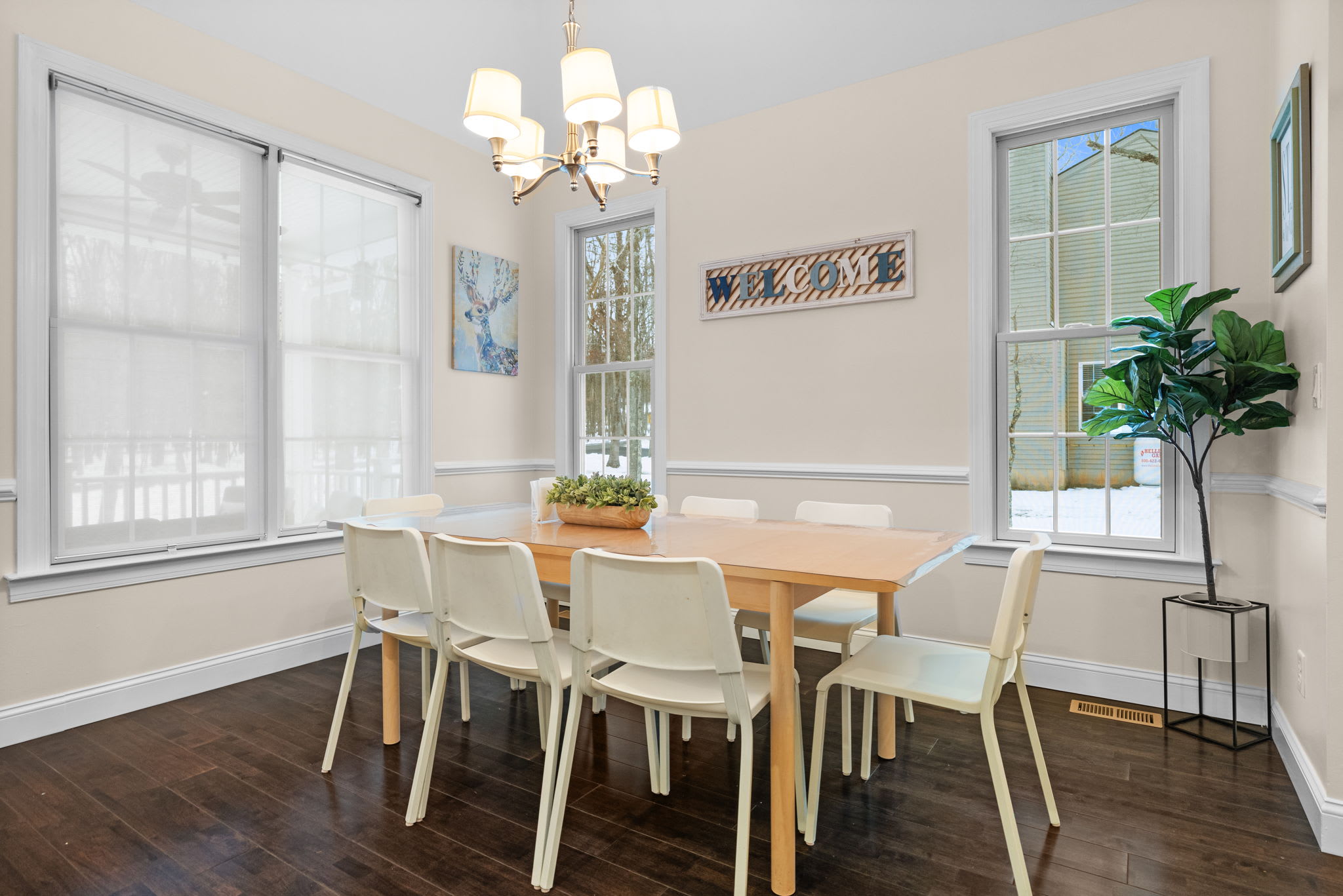 Sun-filled dining area with large windows showcasing serene Pocono forest views