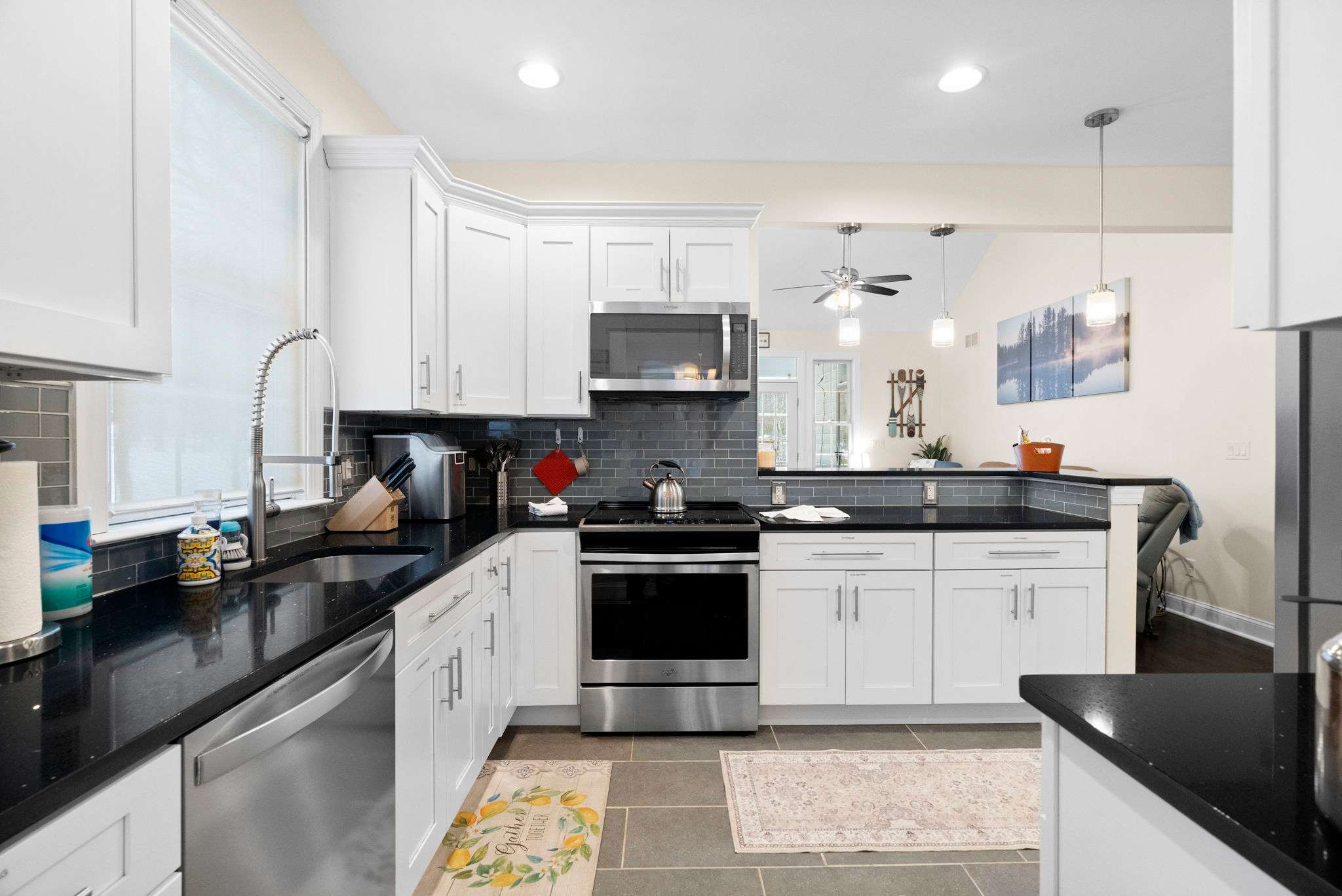 Modern fully-equipped kitchen with stainless steel appliances, breakfast bar and ample seating for groups