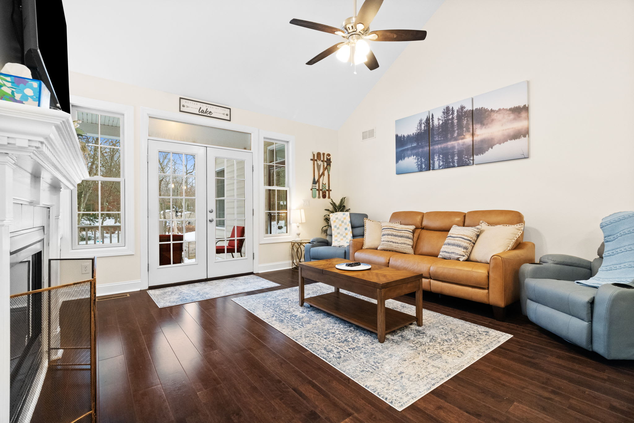 Comfortable living room with designer furniture, ceiling fan and stunning panoramic forest views