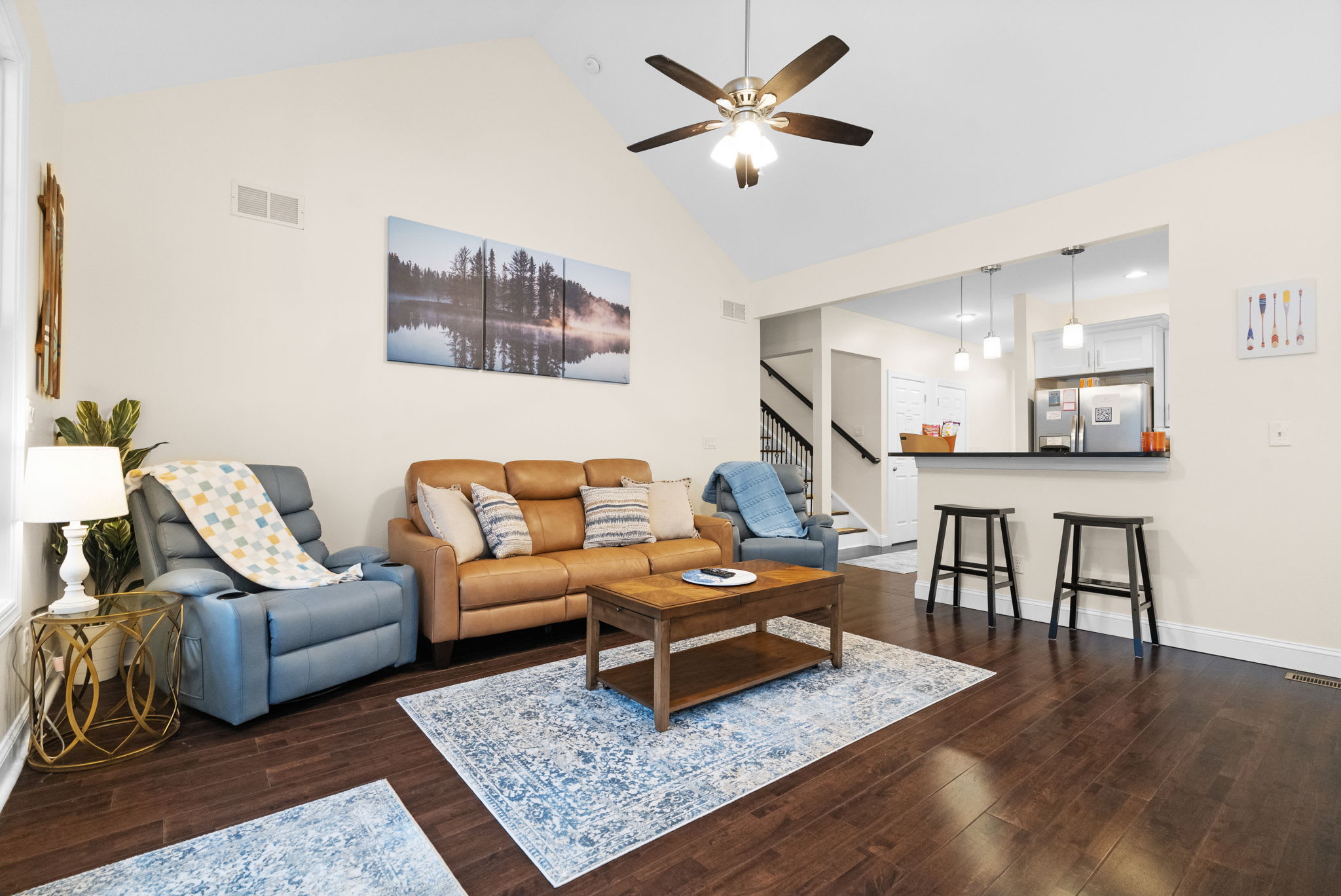 Spacious living area with plush seating, area rug and ceiling fan - your Poconos home away from home