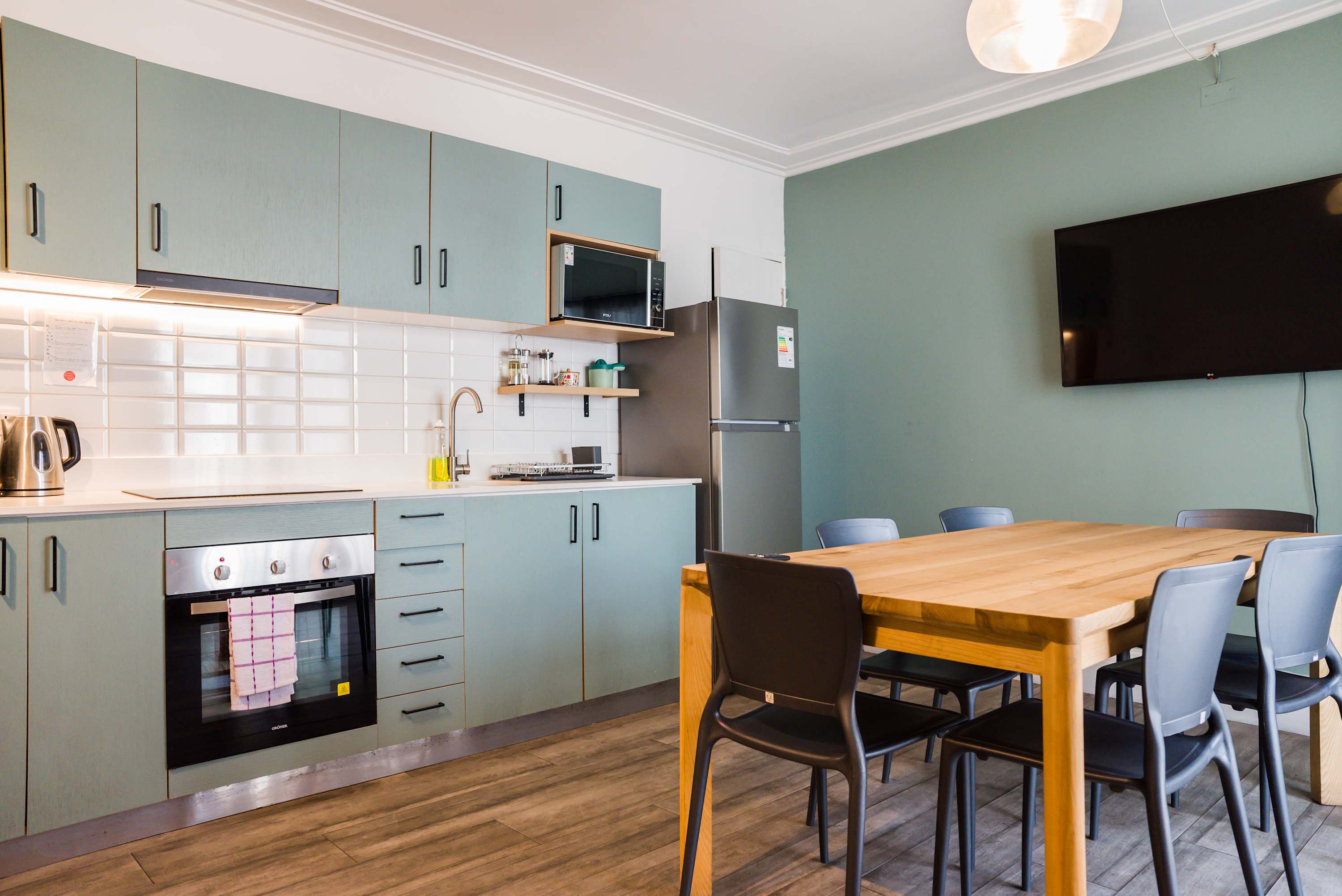 Spacious, modern kitchen with sleek appliances and a cozy dining area perfect for gatherings.