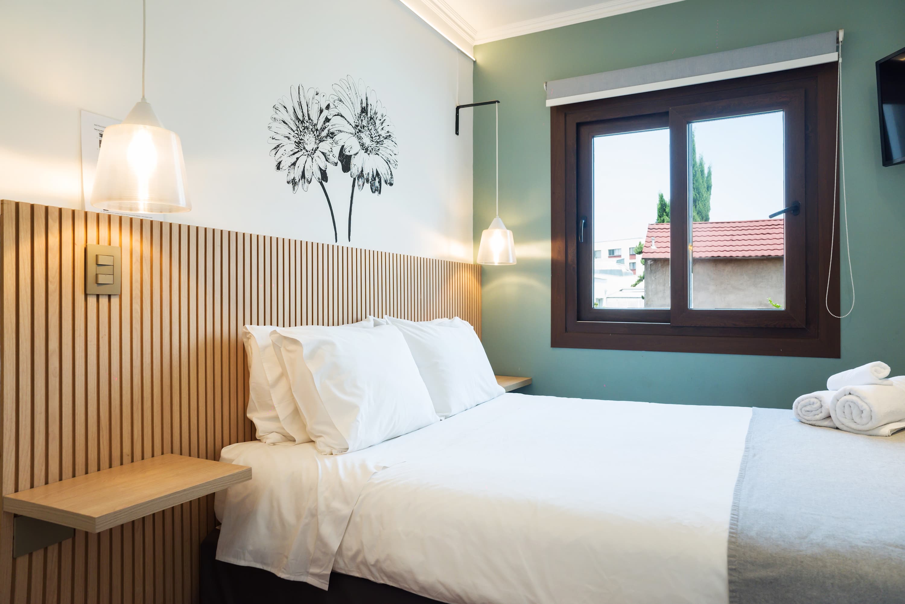 Relax in this bright and cozy bedroom with stylish decor and natural light.