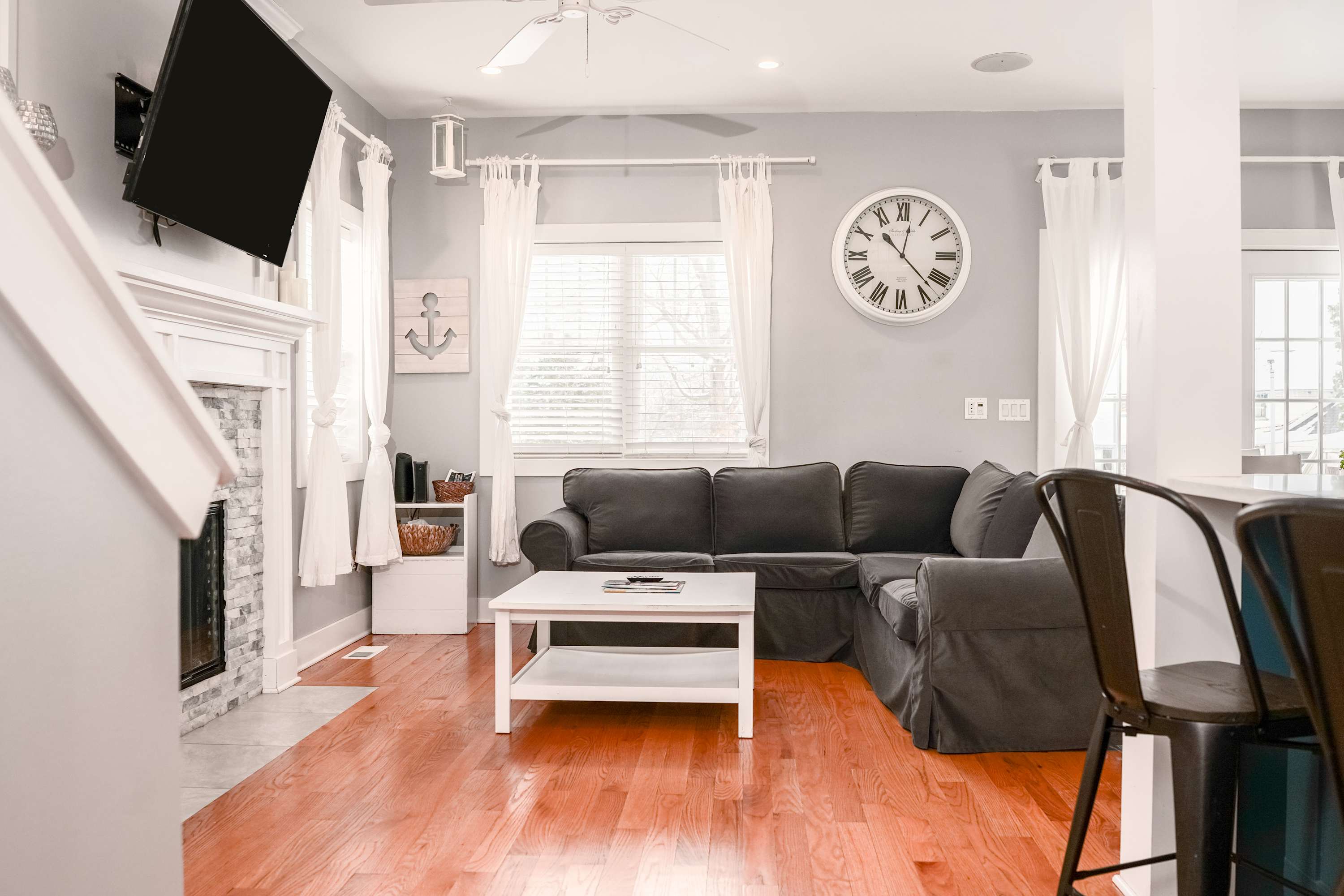 Open concept living area with comfortable couch and smart TV