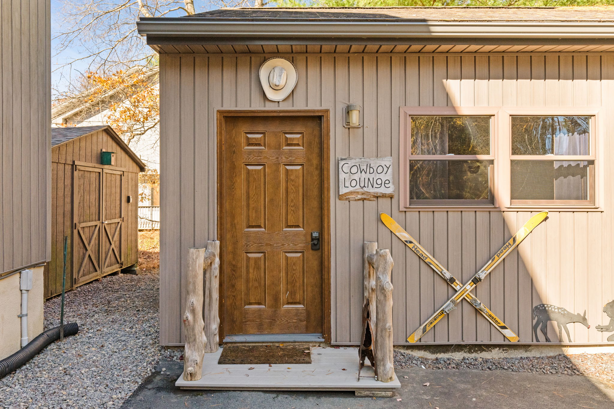 Welcoming front entry door with seasonal wreath - warm mountain home entrance