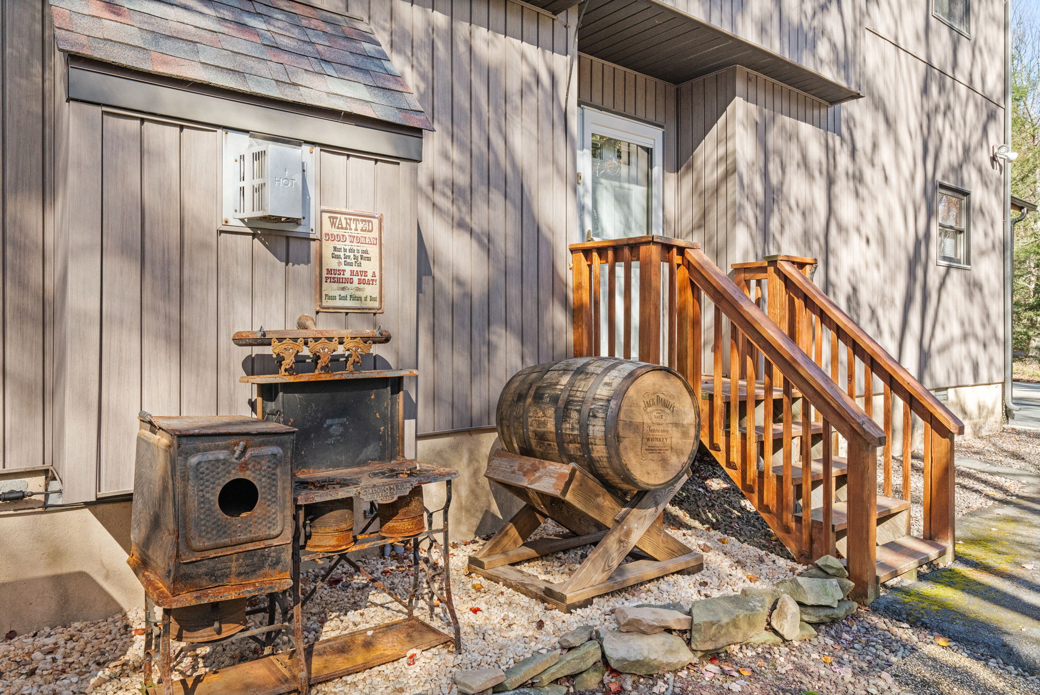 Lower level recreation room with rustic stone fireplace and staircase (not operational stricly for decoration pusposes) - cozy gathering space for guests