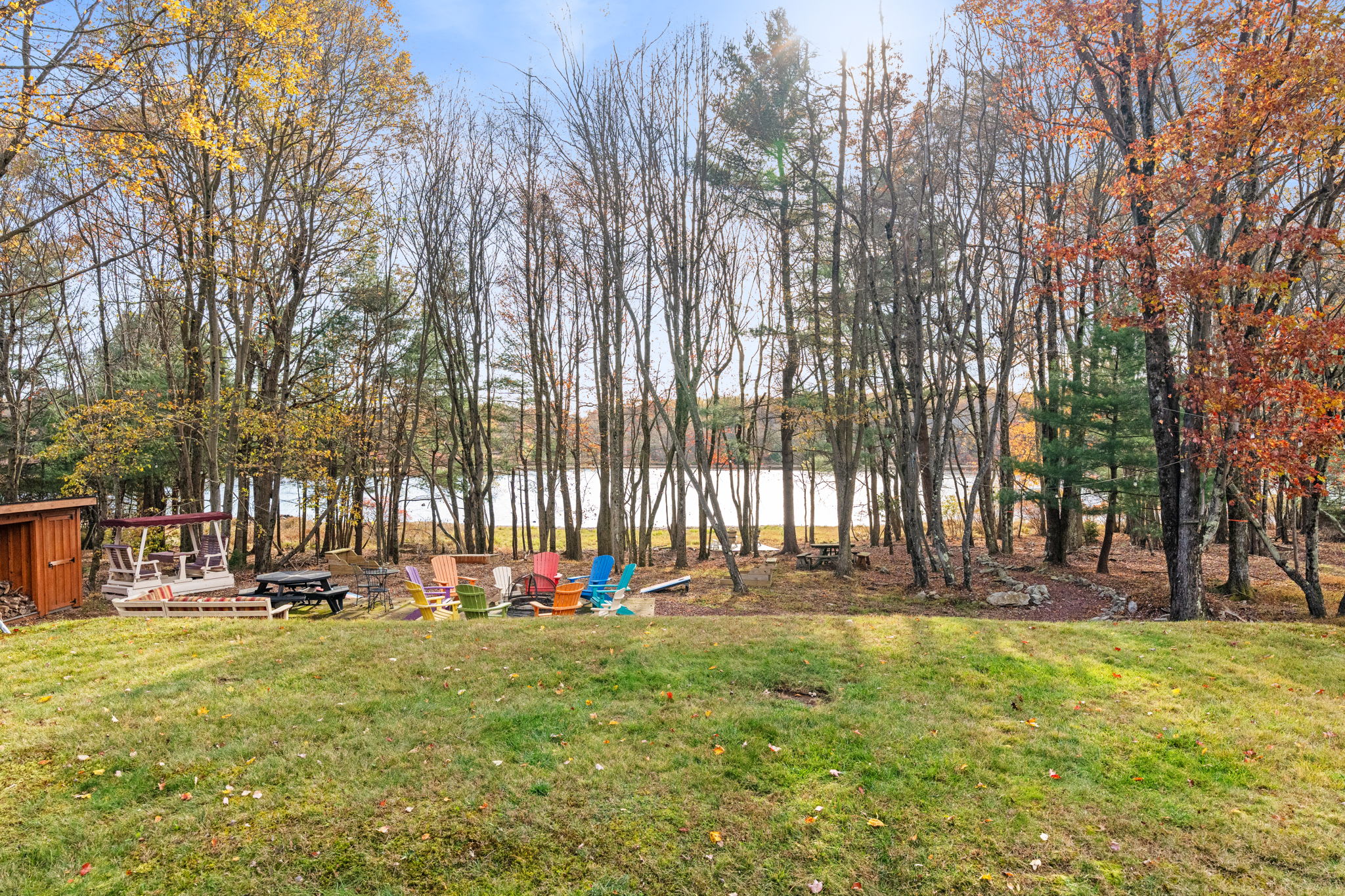 Expansive backyard with children's playground in wooded natural setting - safe outdoor play space for kids