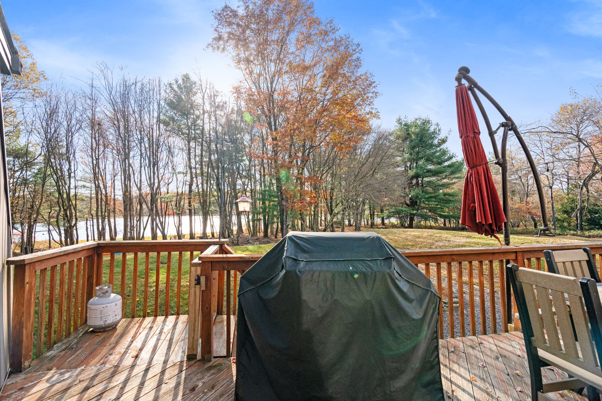 Deck with gas grill and patio umbrella for outdoor cooking and dining - enjoy meals in the fresh mountain air