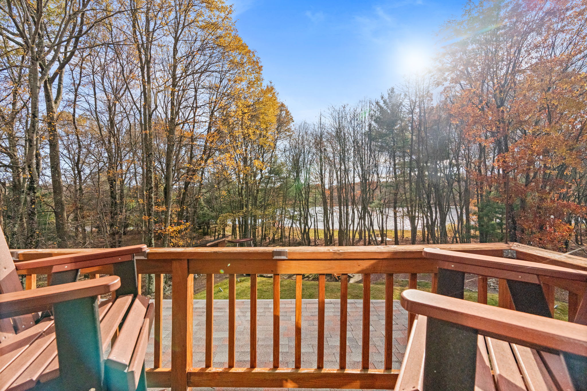 Expansive wooden deck overlooking serene woods - enjoy peaceful nature views from your private retreat