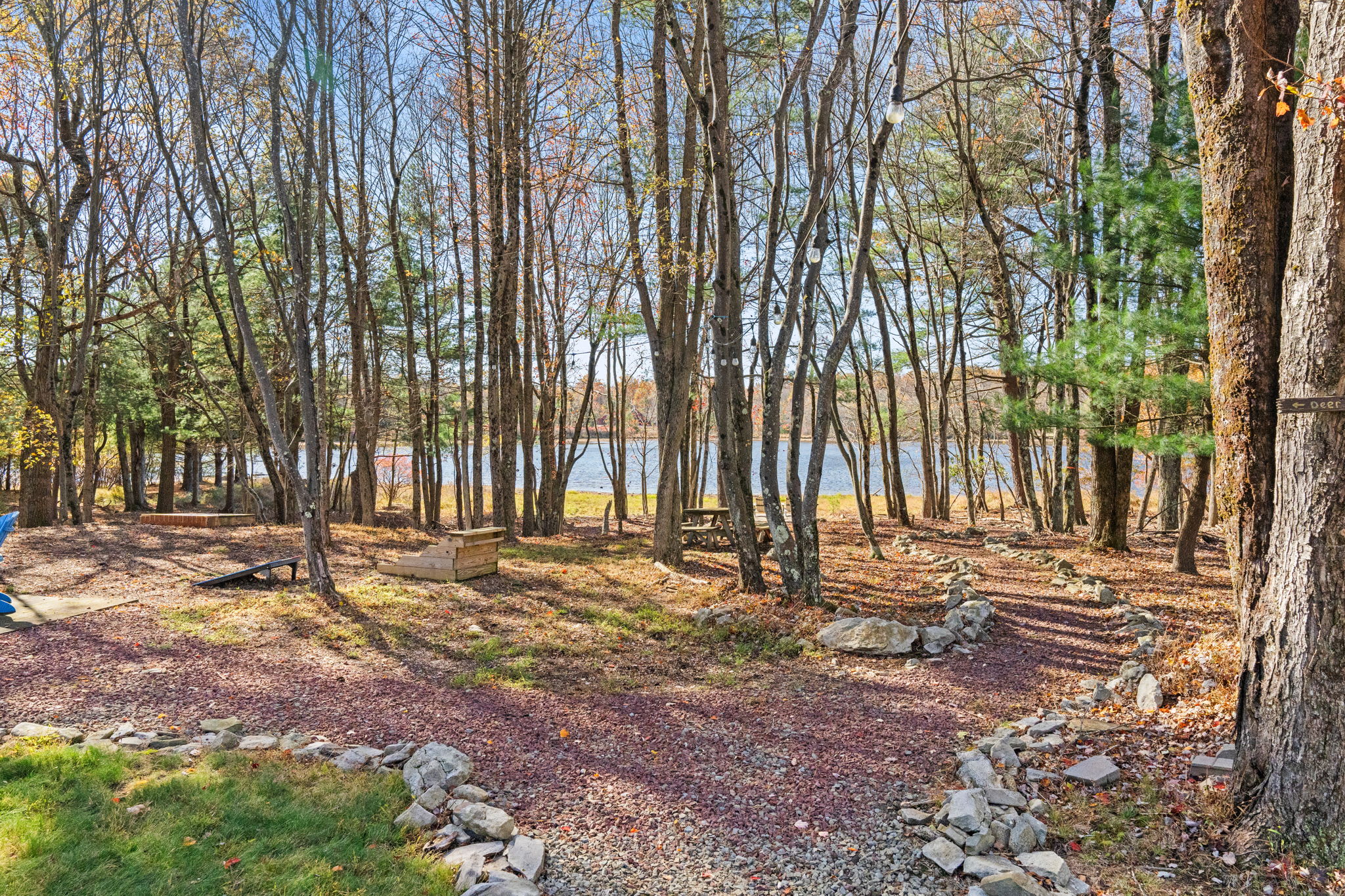 Fire pit area with colorful Adirondack seating arrangement - gather around the campfire for s'mores and stories