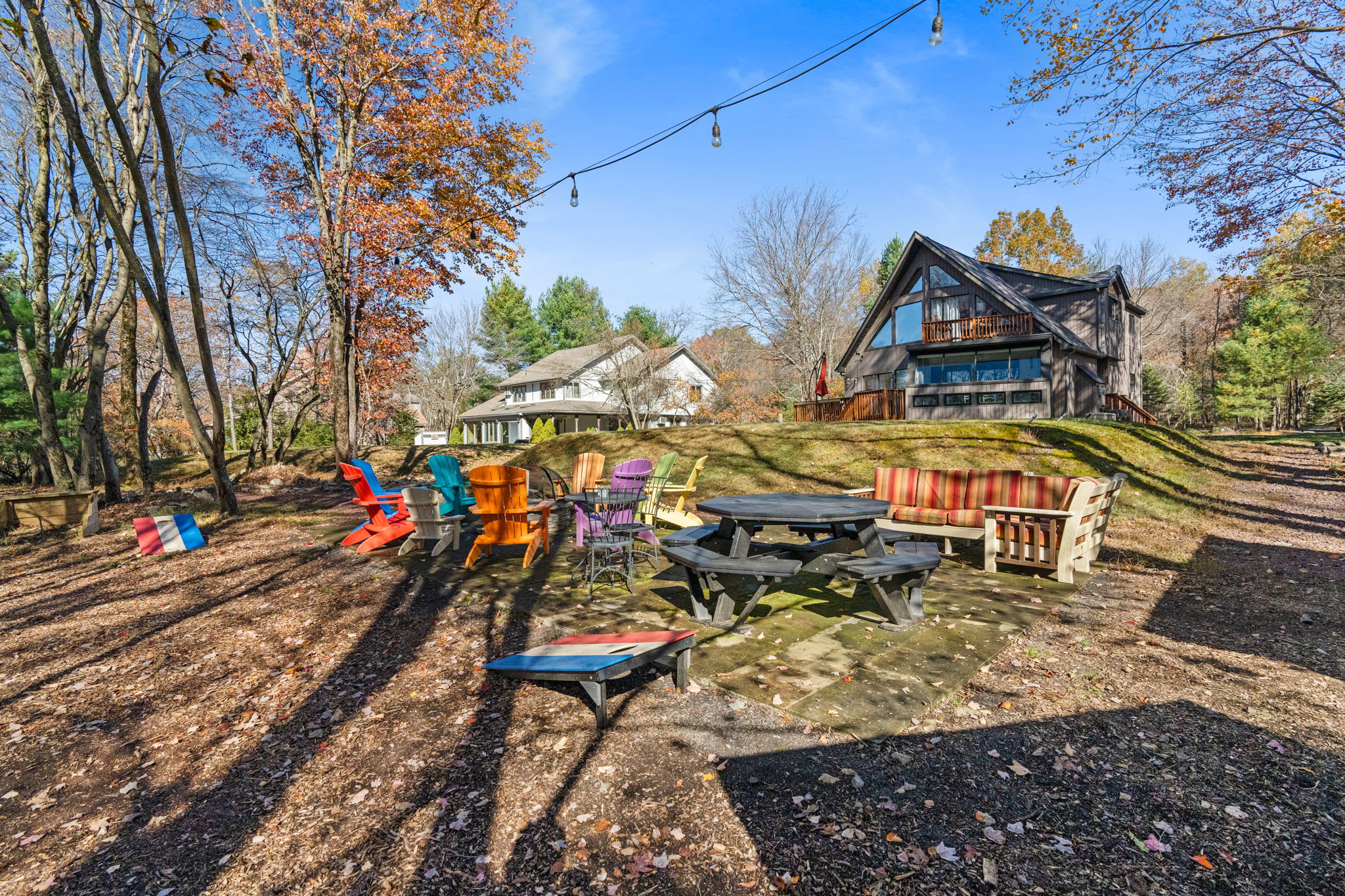 Kids' playground with swing set and climbing equipment in wooded backyard - family-friendly outdoor recreation