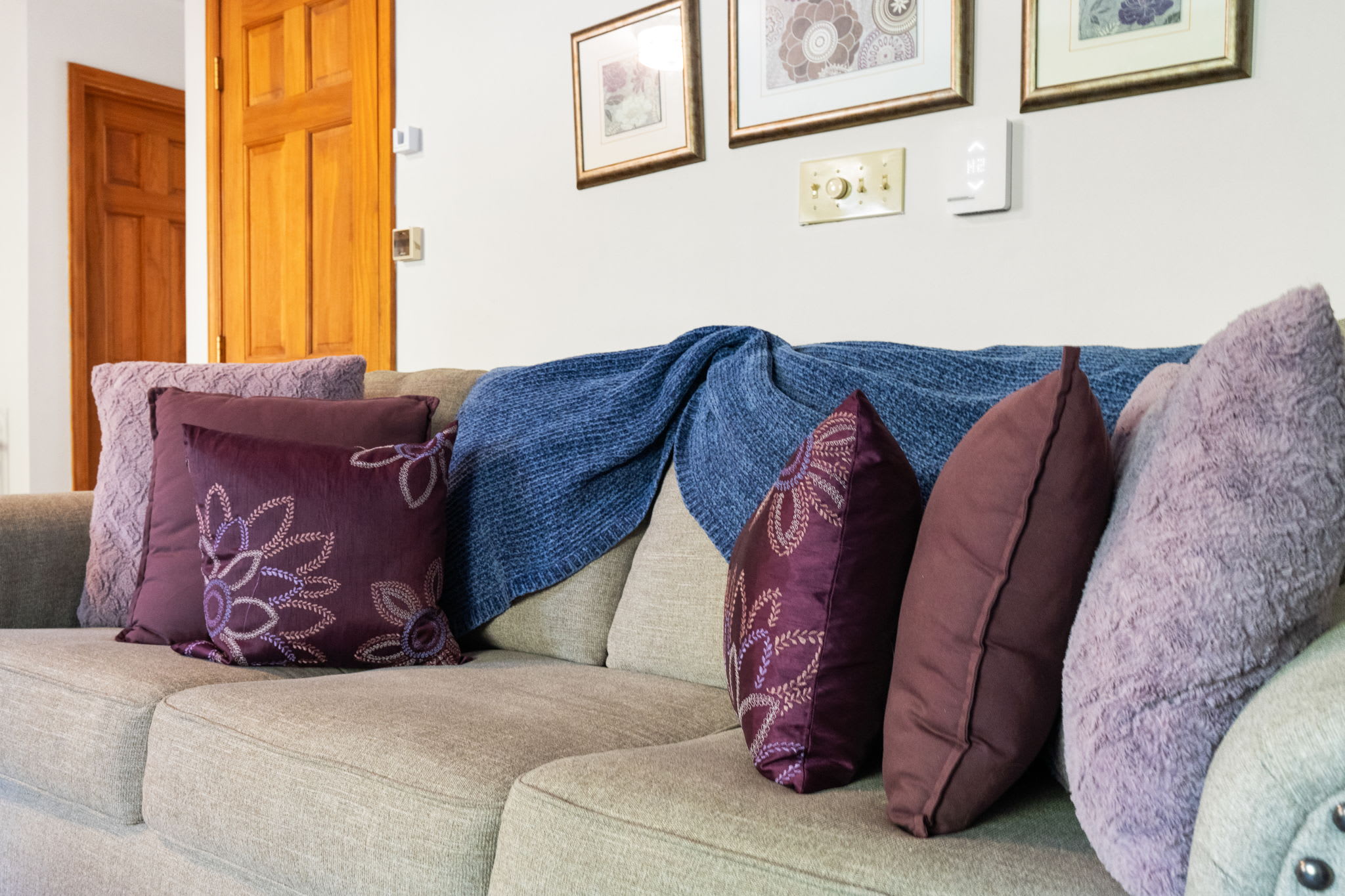 Bedroom with decorative throw pillows and comfortable bedding - restful sleeping accommodations