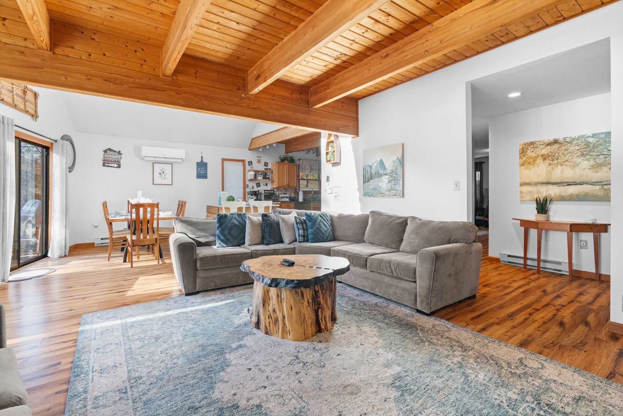 Open-concept living area with high ceilings and natural wood - spacious mountain retreat design