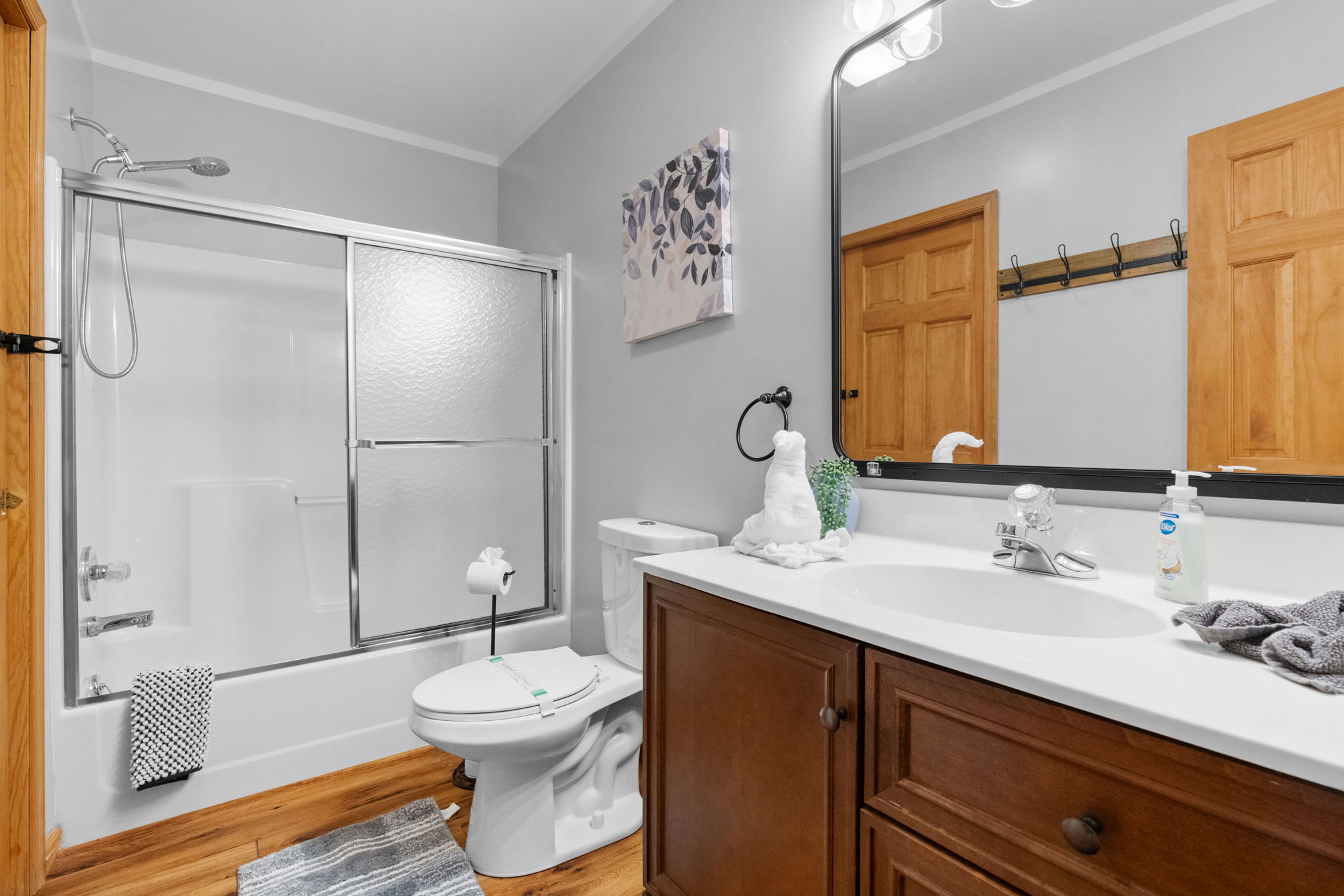 Full bathroom with tub/shower combination and modern fixtures - convenient amenities for guests