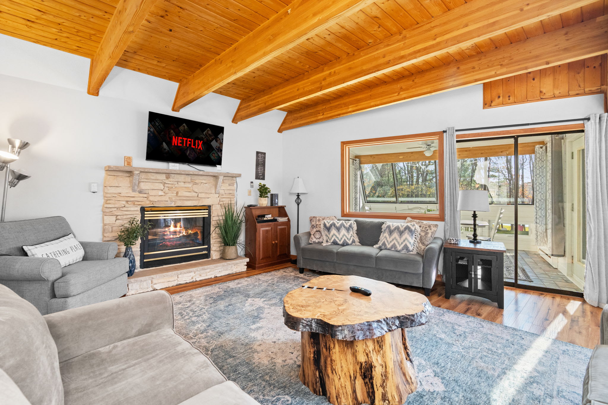 Living room with flat-screen TV and stone fireplace - entertainment center for movie nights