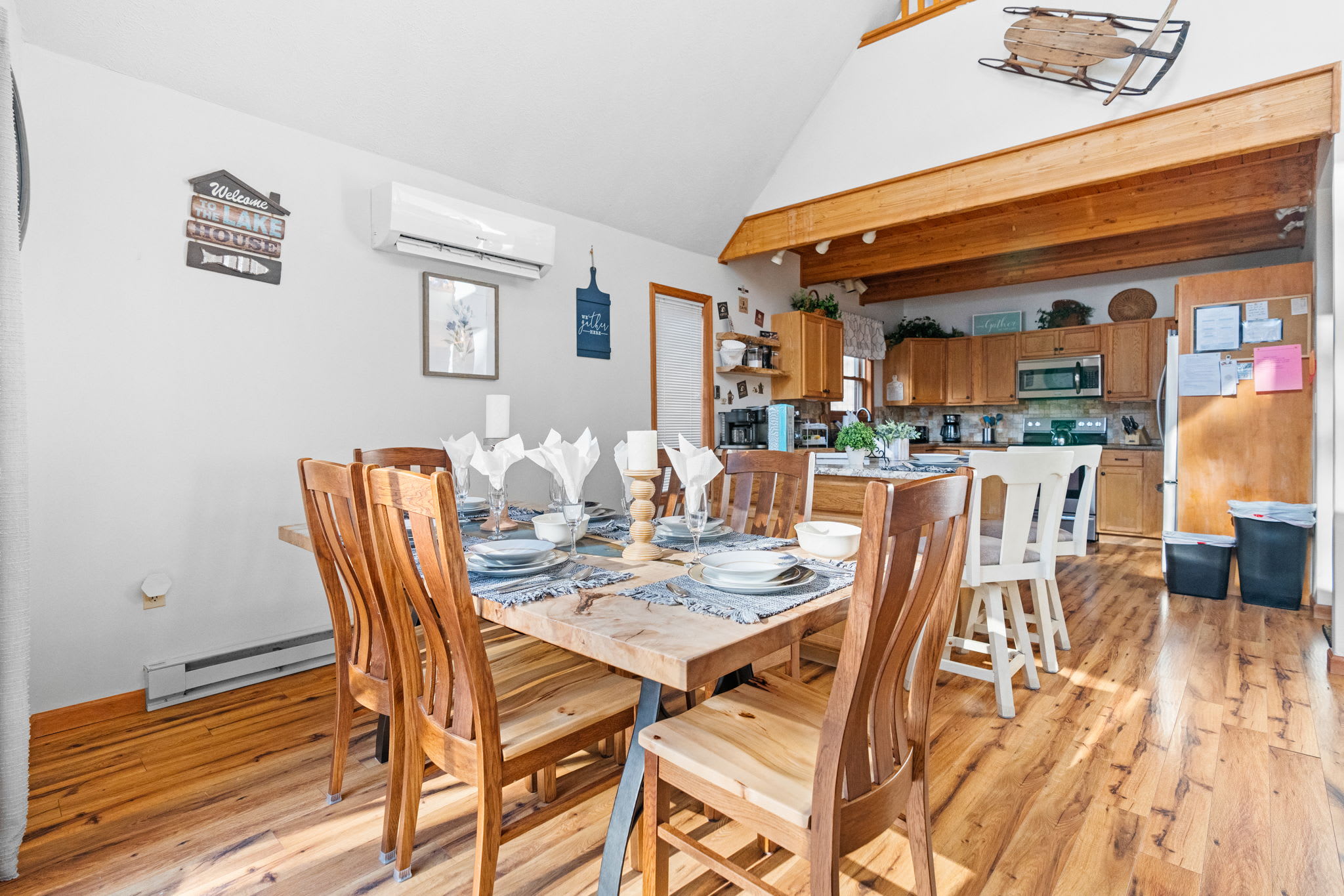 Dining area with view to kitchen and exposed wood beams - open concept design for easy hosting
