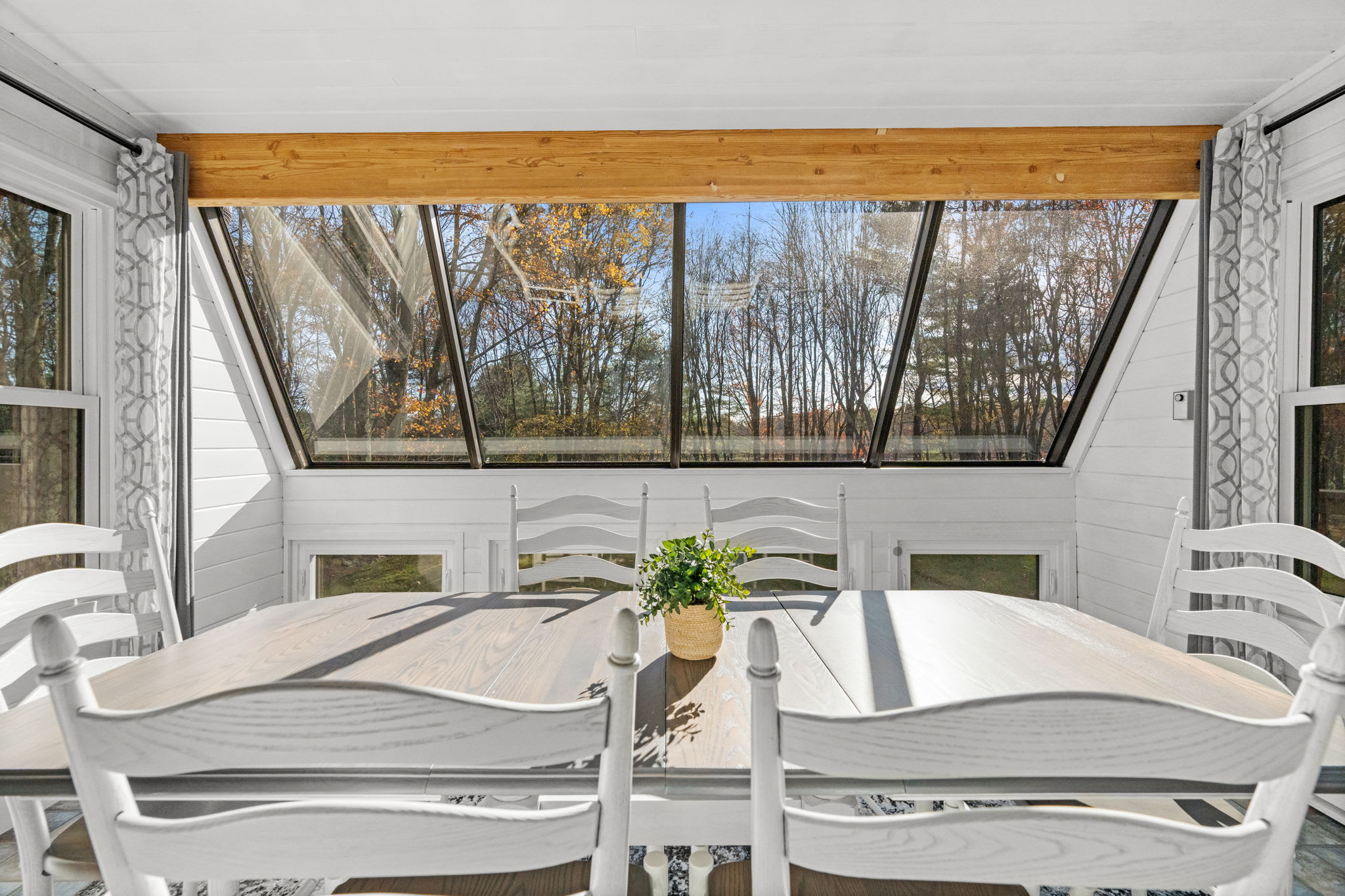 Sunroom with skylight and comfortable seating - sun-filled bonus space for morning relaxation