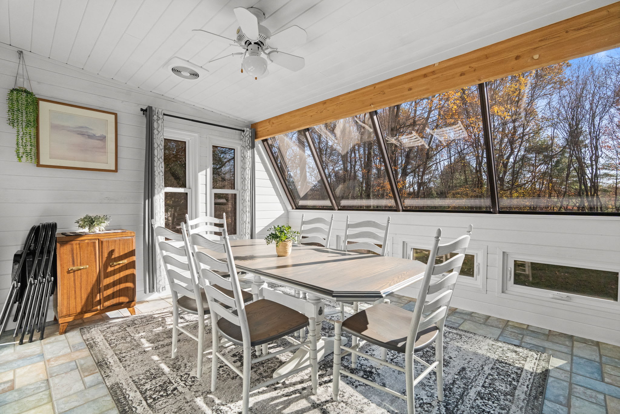 Bright sunroom with large windows and natural light - peaceful reading nook with skylight