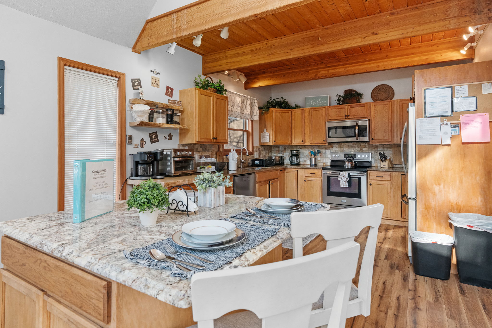 Kitchen with wood cabinetry and modern appliances - fully stocked for meal preparation