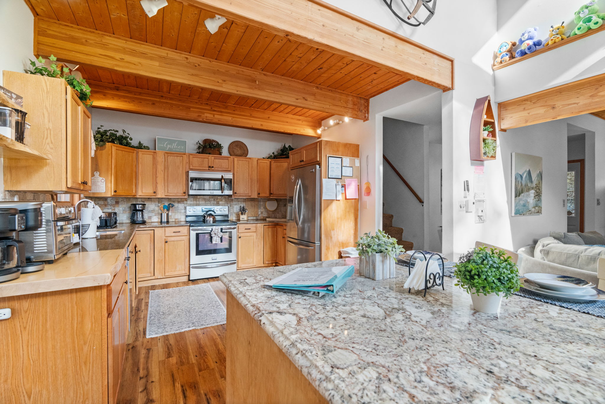 Kitchen featuring wood cabinetry and cathedral ceilings - rustic mountain charm with modern conveniences