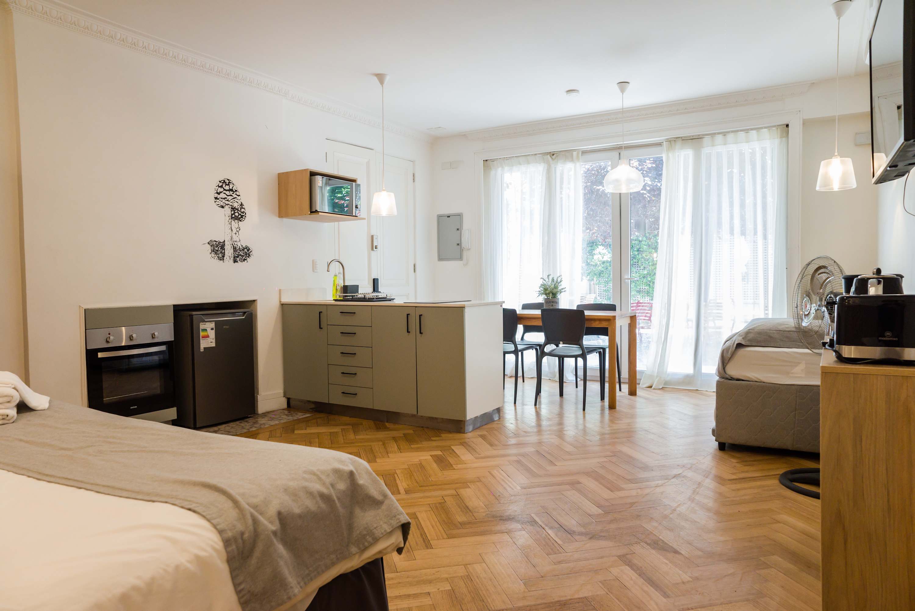 Cozy studio with modern amenities and a bright dining area, perfect for a comfortable stay.