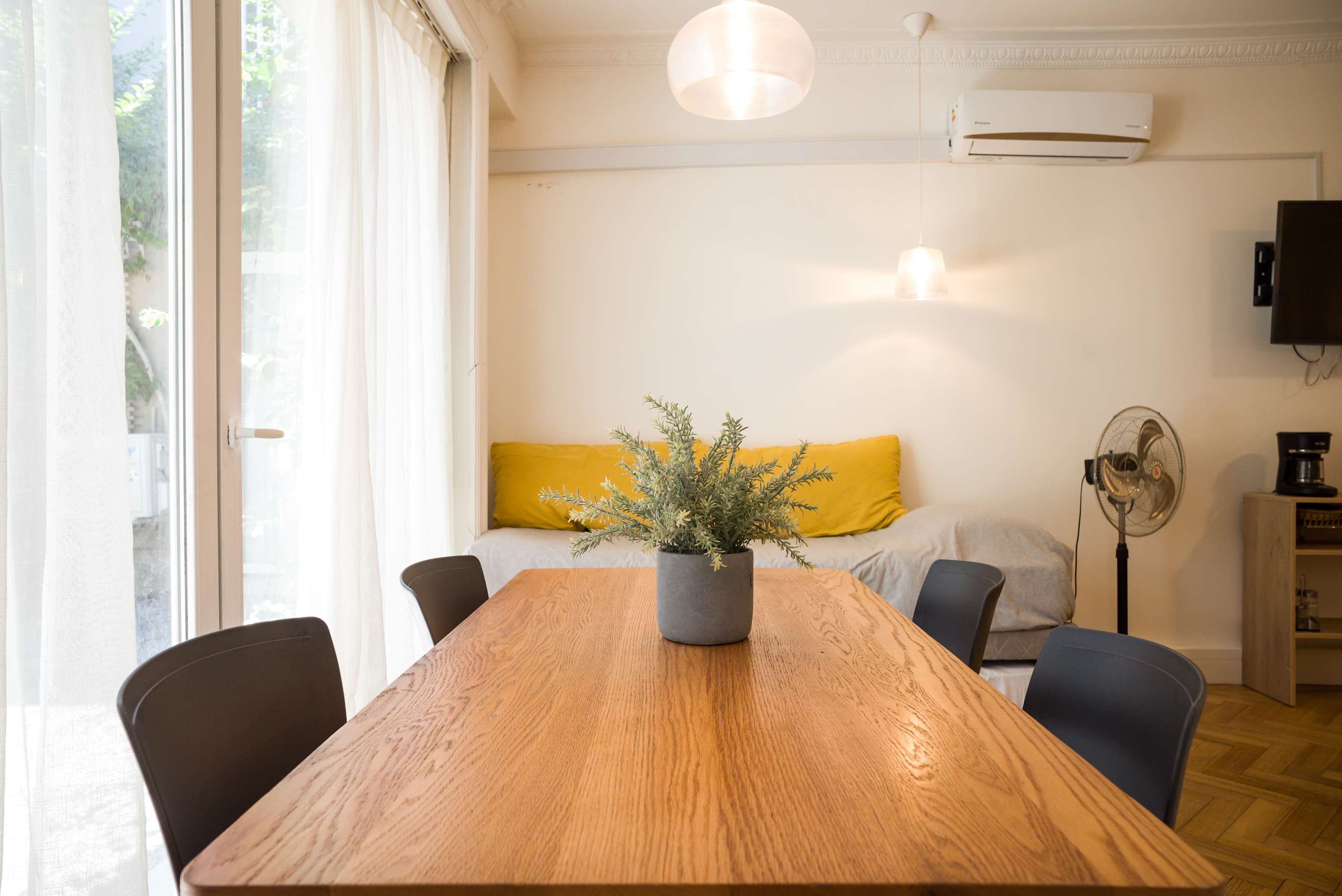 Bright and cozy dining area with natural light, perfect for relaxing meals or work-from-home days.