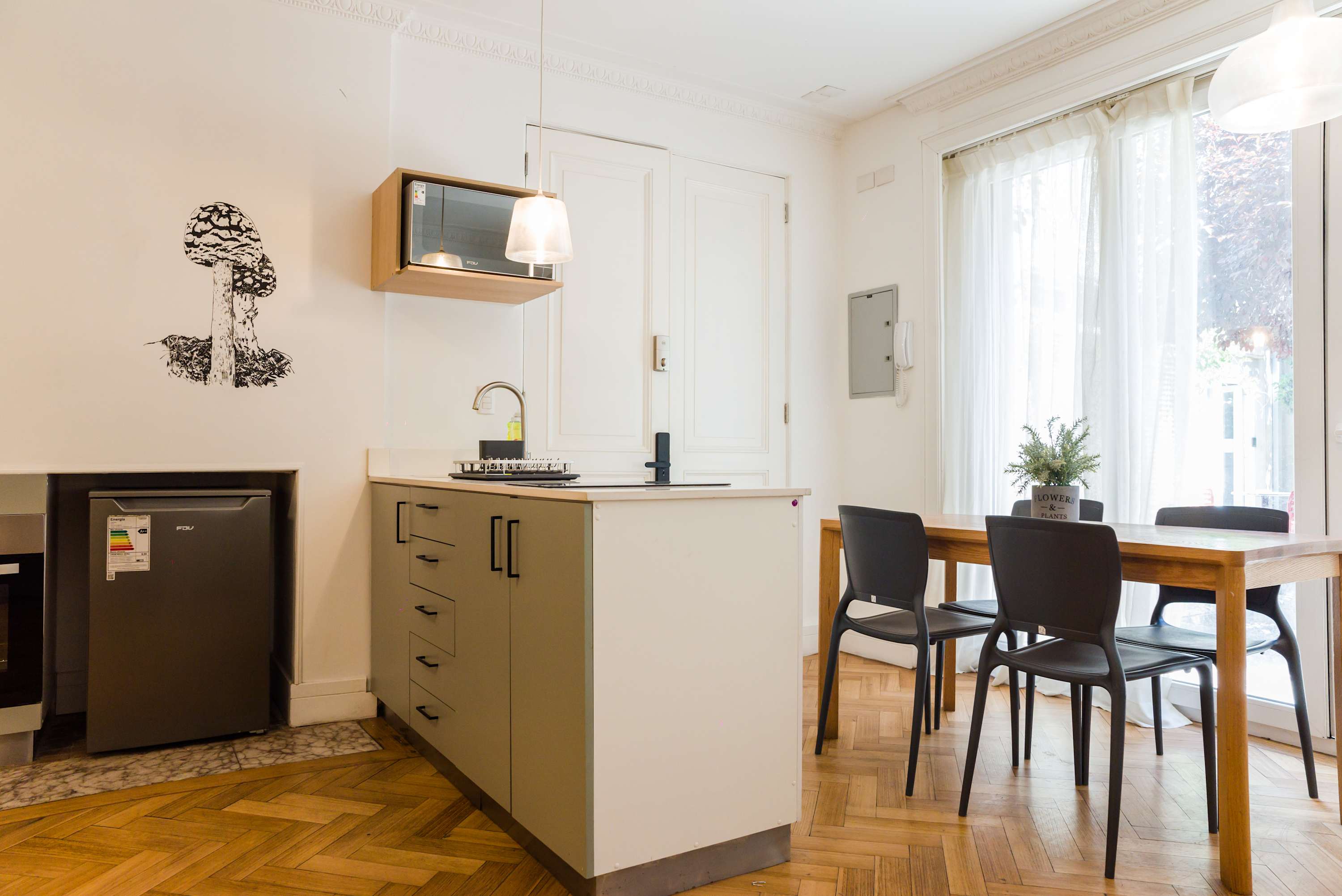 Bright and cozy kitchen with dining area, perfect for enjoying meals by the window.
