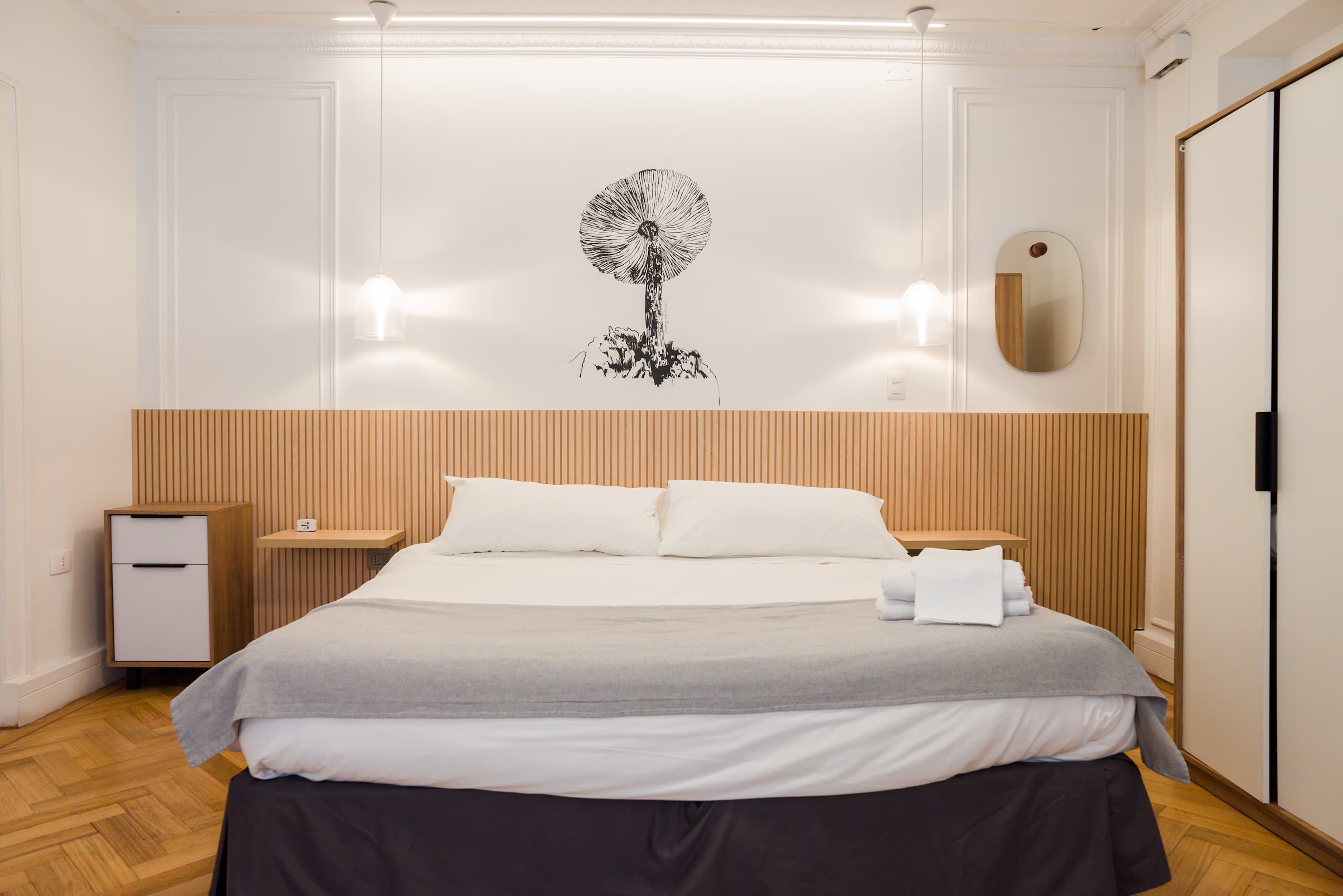 Relax in this stylish bedroom with modern decor and cozy lighting, perfect for a restful stay.