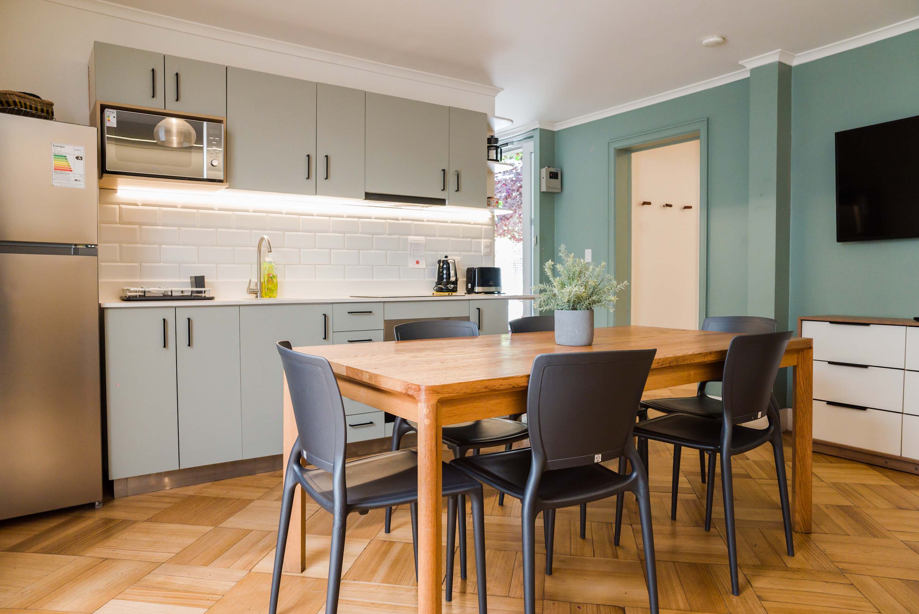 Modern kitchen with dining area, perfect for family meals or casual gatherings.