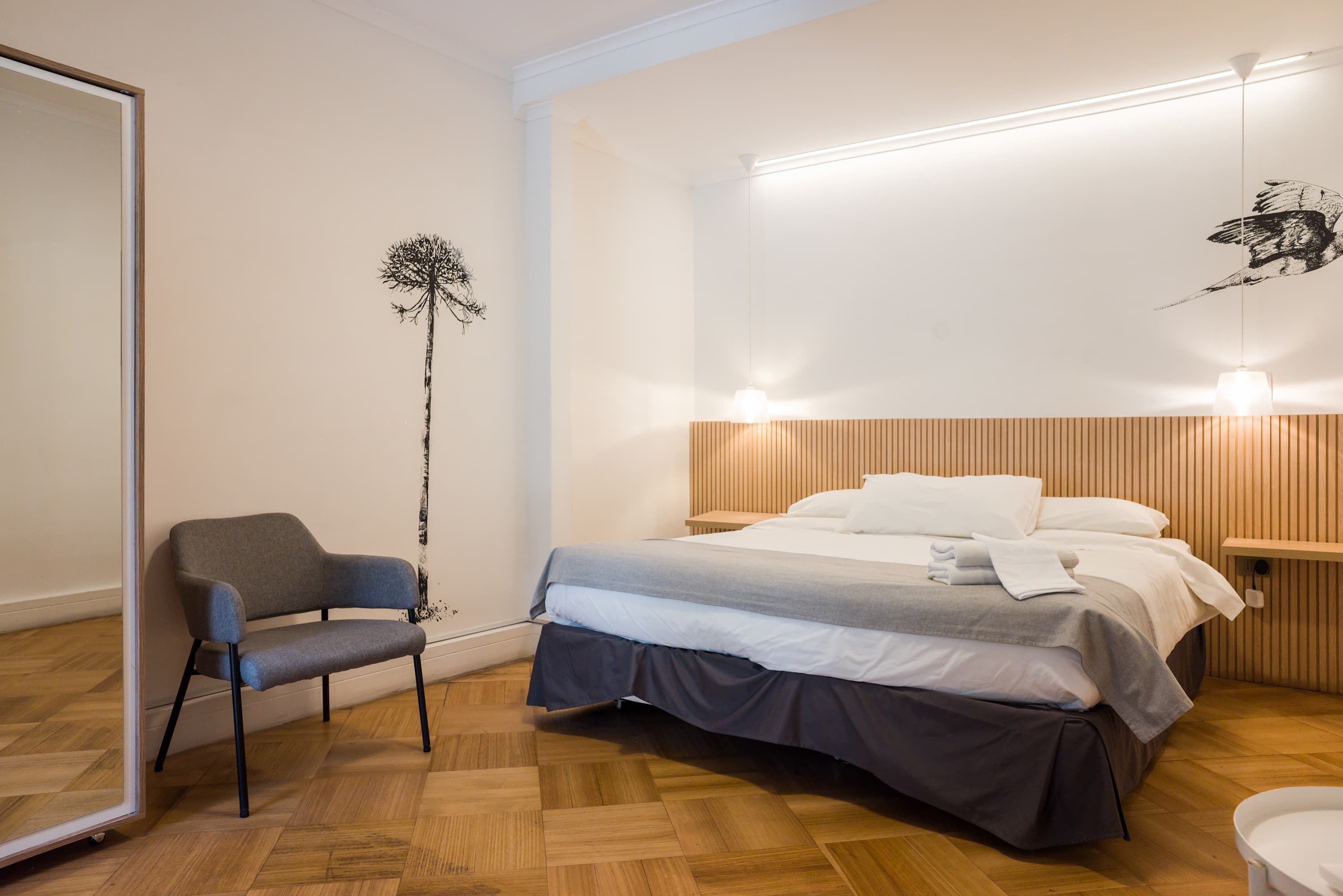 Relax in this stylish bedroom with modern decor and cozy lighting, perfect for unwinding after a day of exploring.