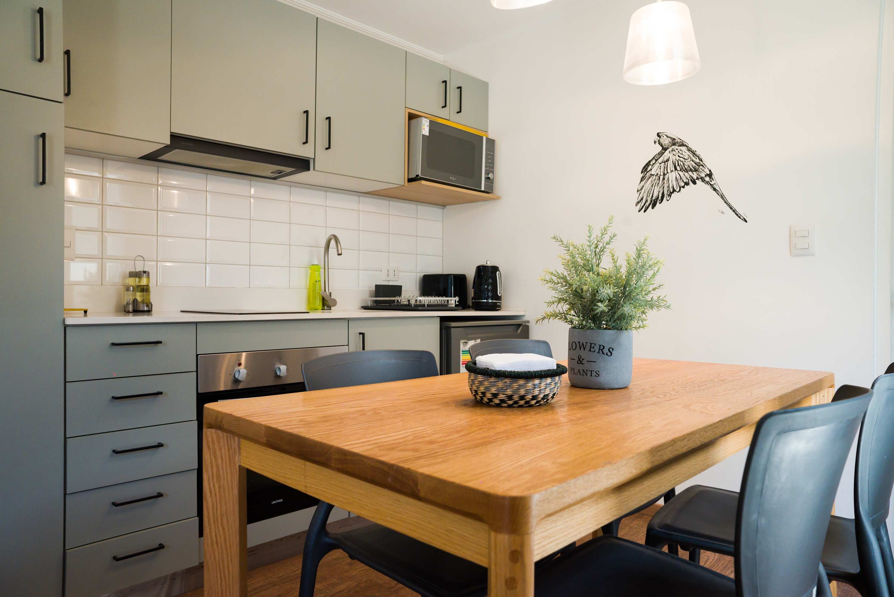 Chic and modern kitchen with stylish dining area, perfect for cozy meals and gatherings.