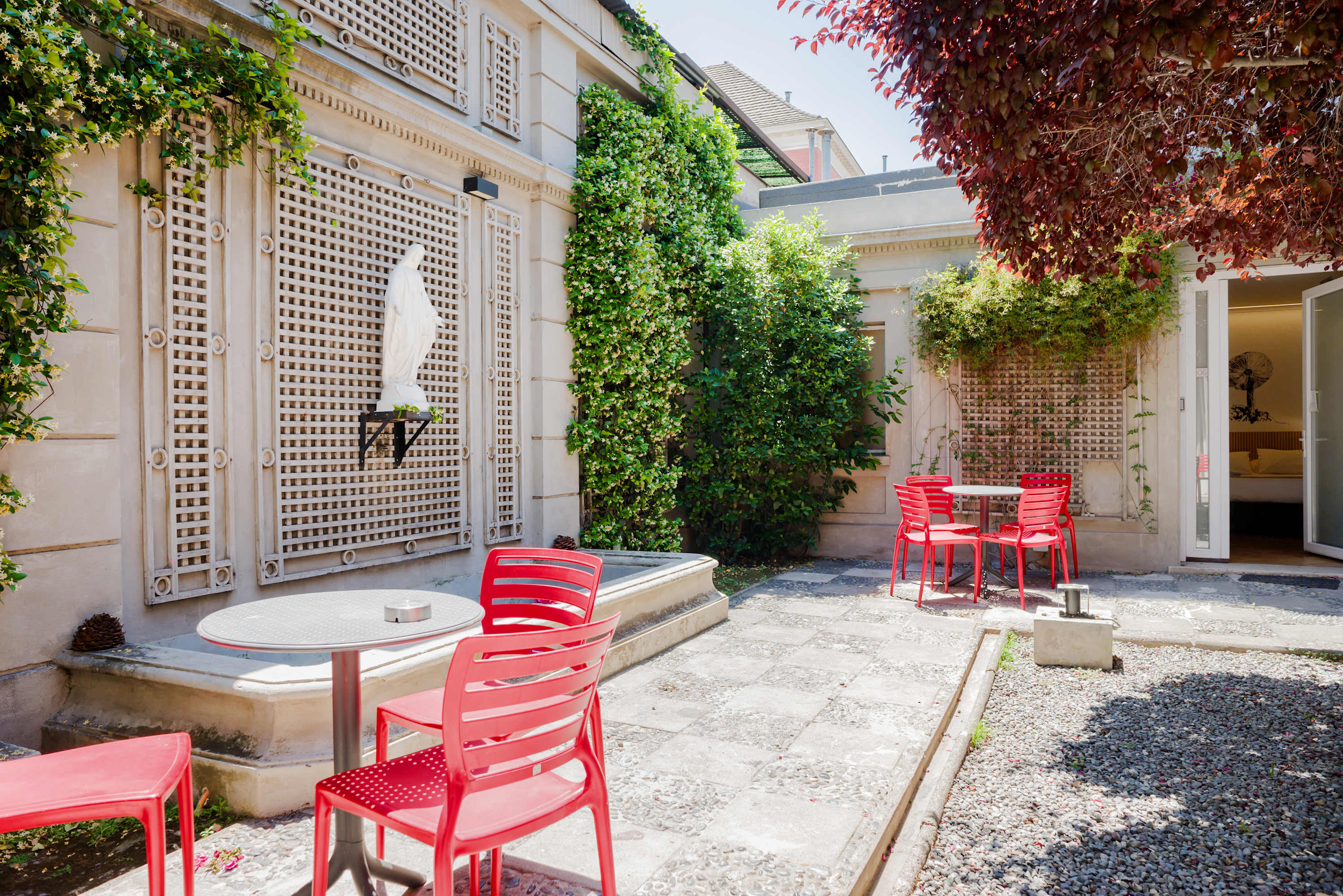 Enjoy a charming outdoor patio with vibrant seating and lush greenery. Perfect for relaxing or socializing. (Common Area)