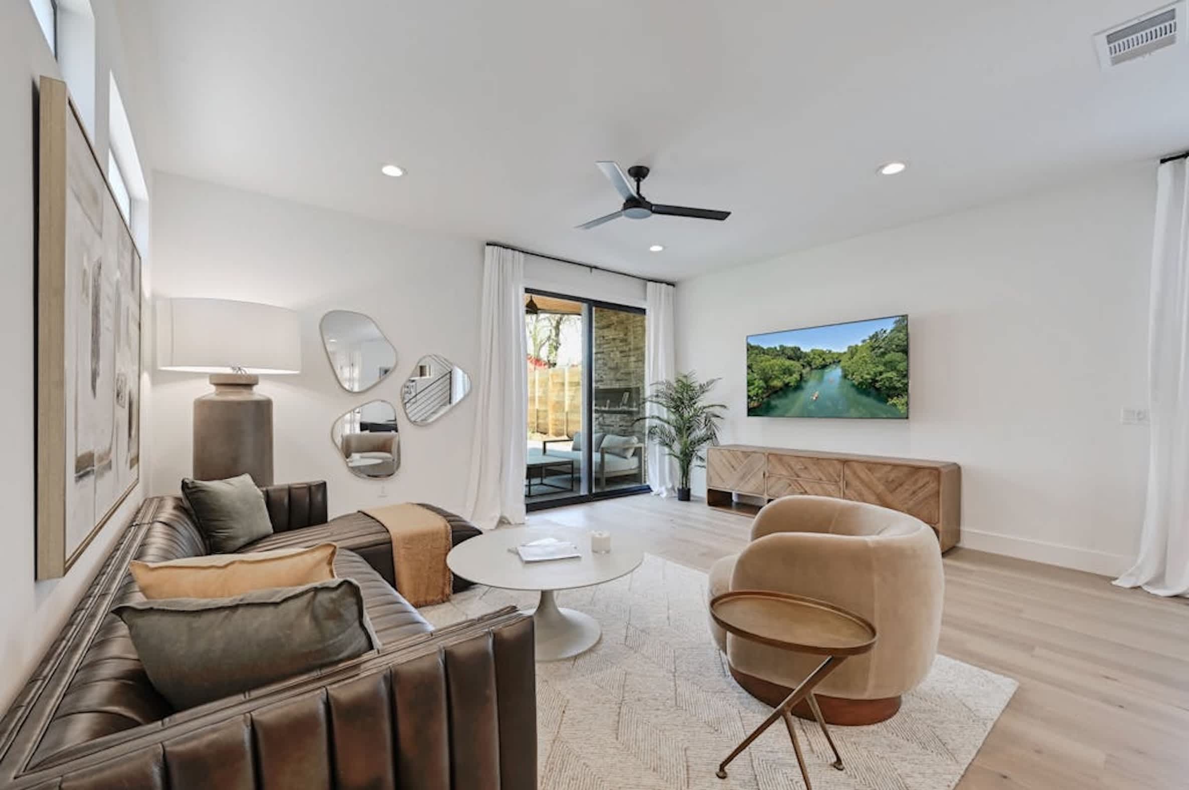 Open-concept living room w/a smart TV & modern, chic decor